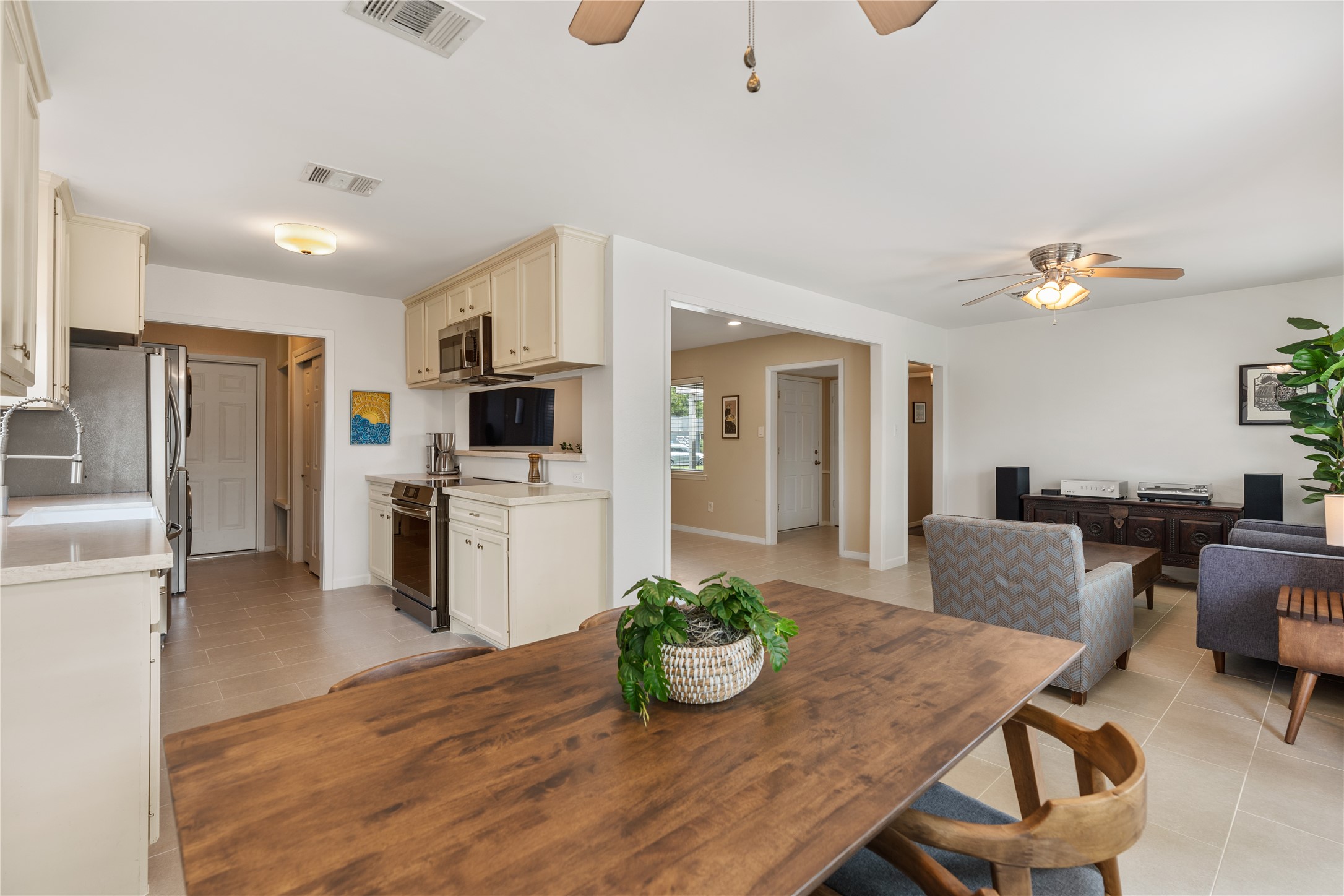 Another view of the open concept design. Beyond the kitchen is the mudroom, pantry, and laundry area connecting to the garage.