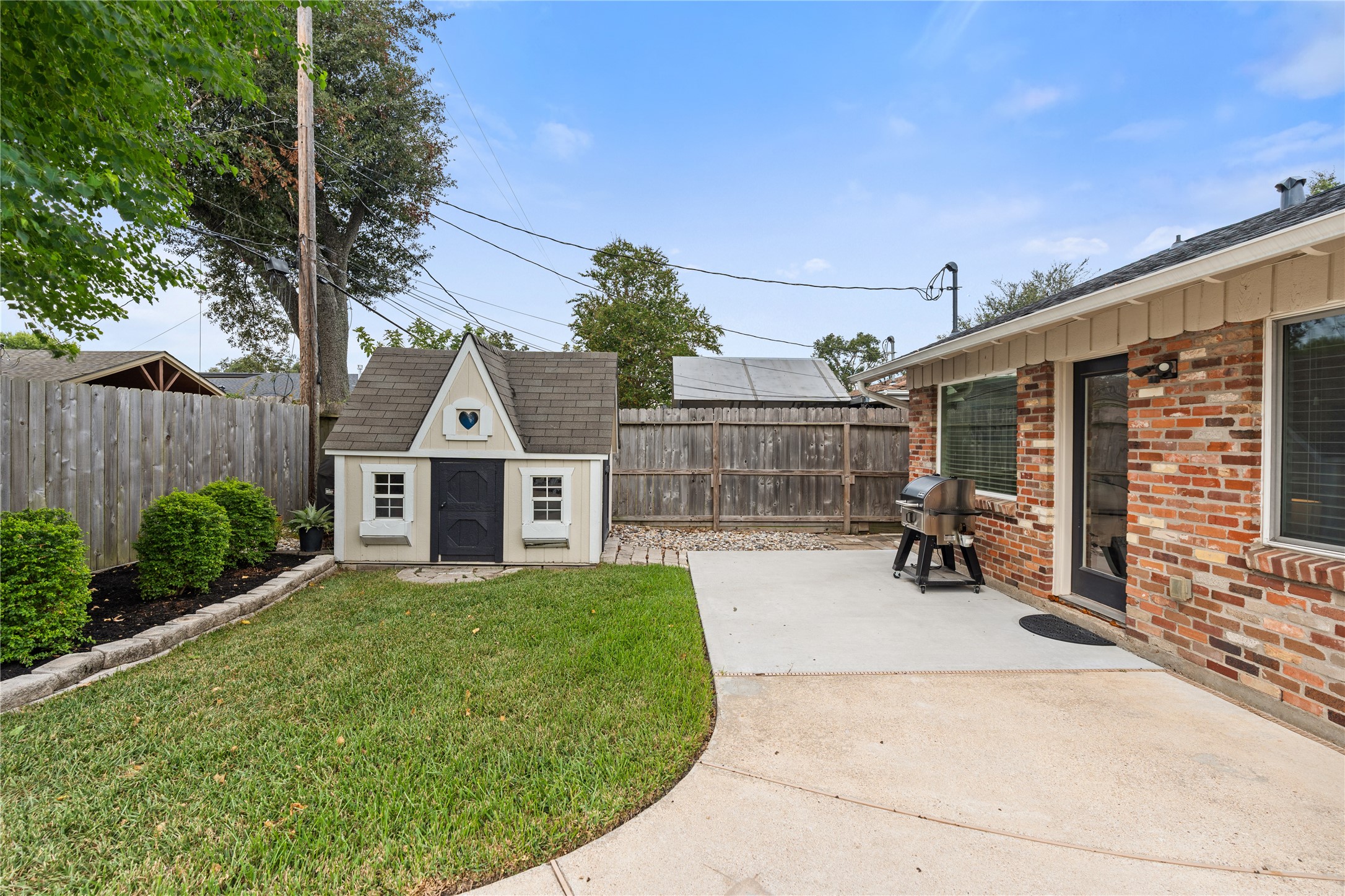 Theres still plenty of backyard beyond the pool, with green space for play or pets + a storage shed that doubles as a playhouse.