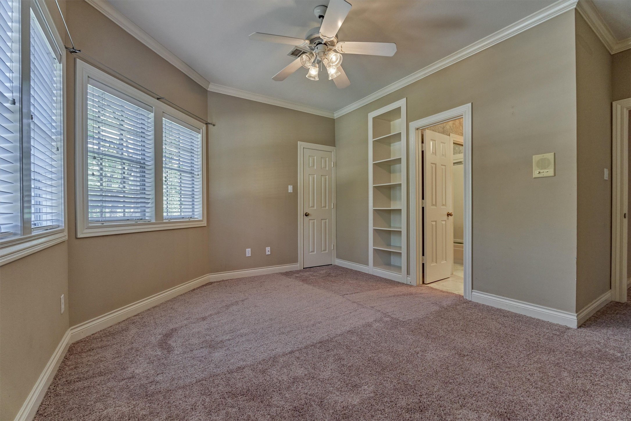 This upstairs bedroom is a private retreat for a teen, guest, or older child. It has an attached bath, a generous walk-in closet, and built-in shelving for books and keepsakes.