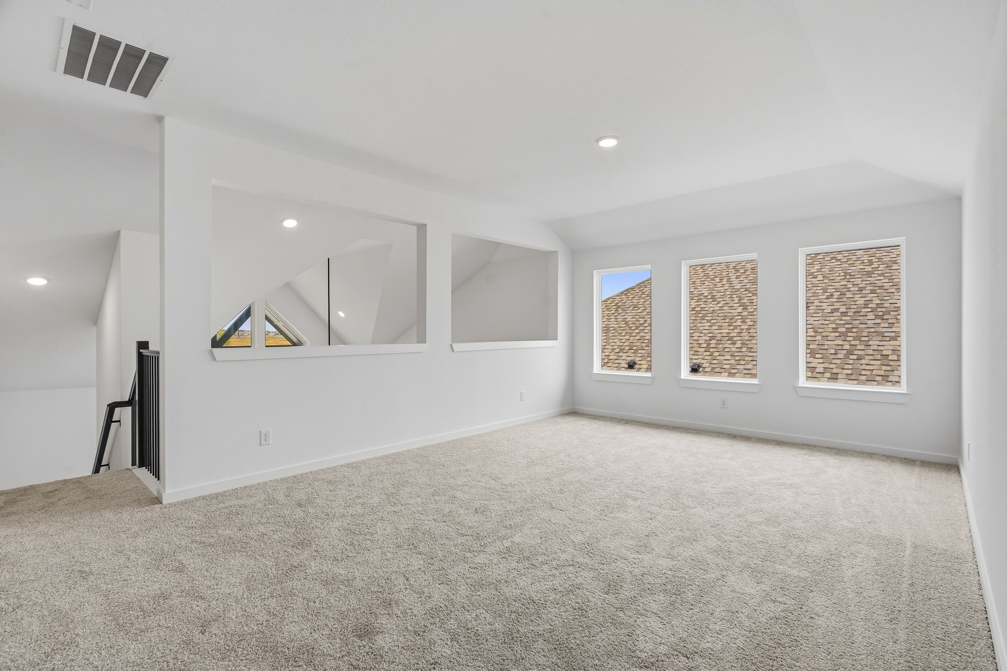 A spacious game room overlooks the first floor.