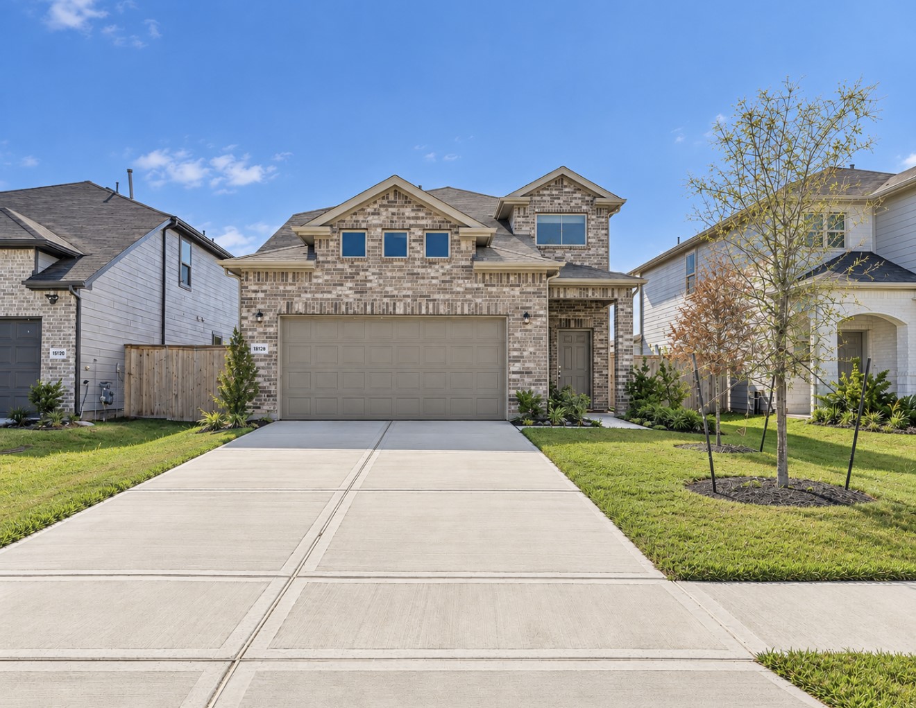 Beautiful two-story home with brick exterior and two car garage and a welcoming front entrance
