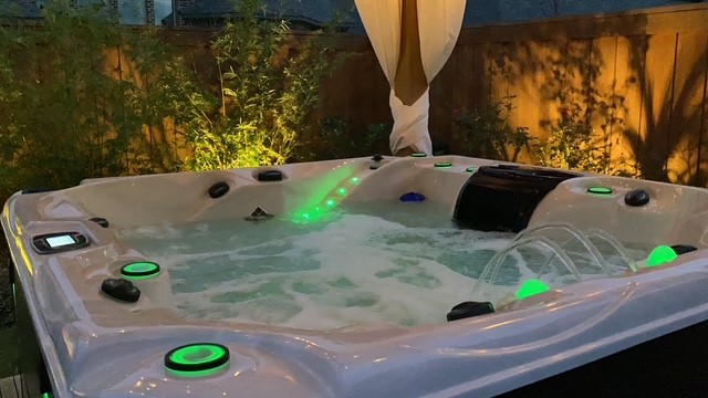 Luxurious outdoor hot tub with soothing jets and ambient lighting, perfect for relaxing evenings.