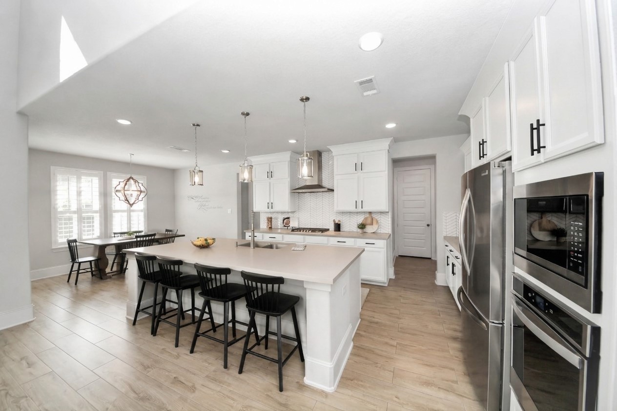 Bright and inviting, this kitchen showcases what it would look like to paint the cabinets white, offering a glimpse into its stylish potential.