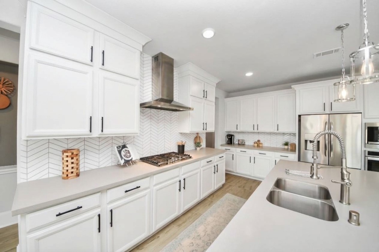 Virtually staged with white cabinets to show what it could look like if cabinets were painted.