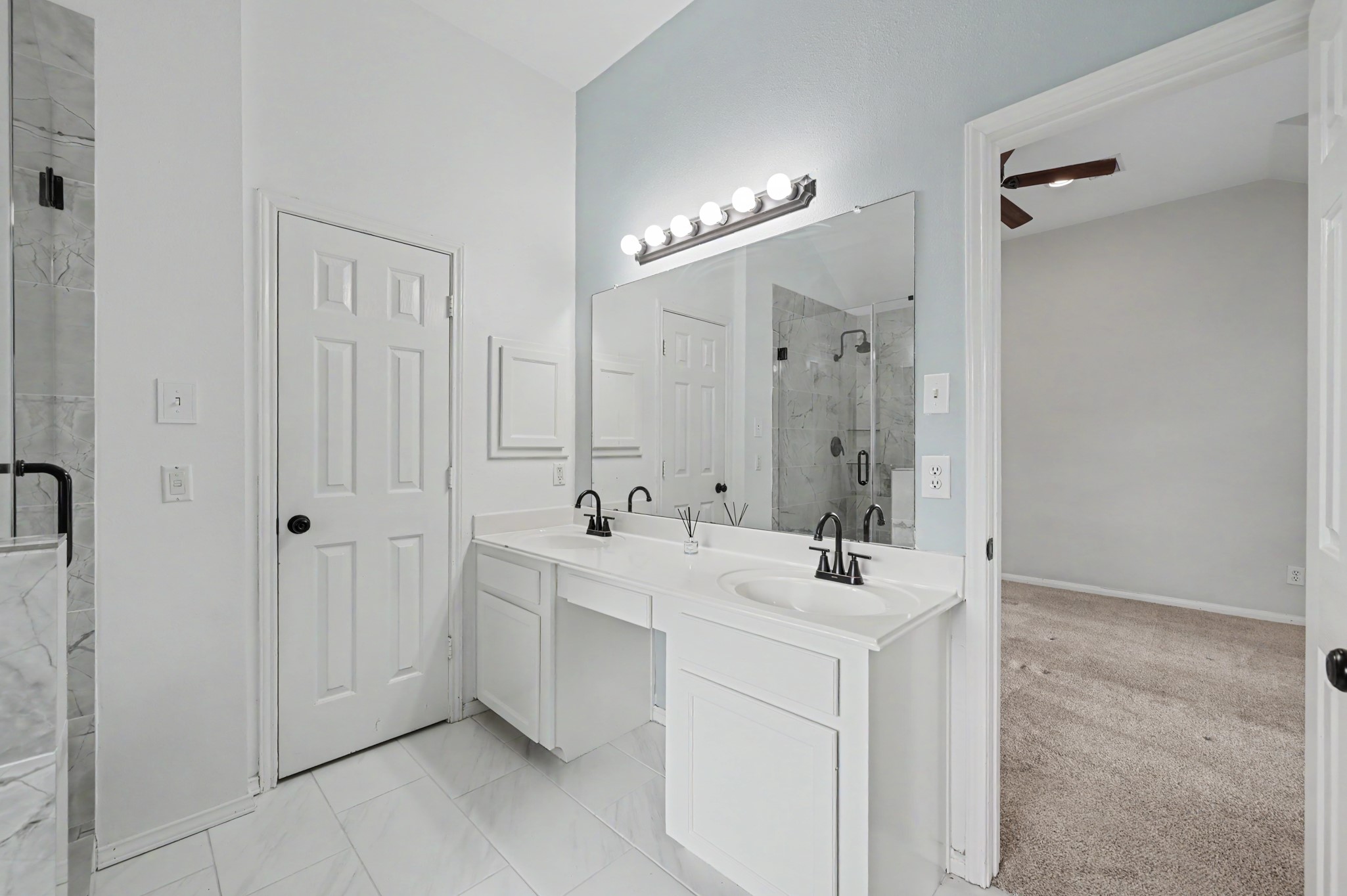 Primary bathroom with his & hers sinks & vanity area.