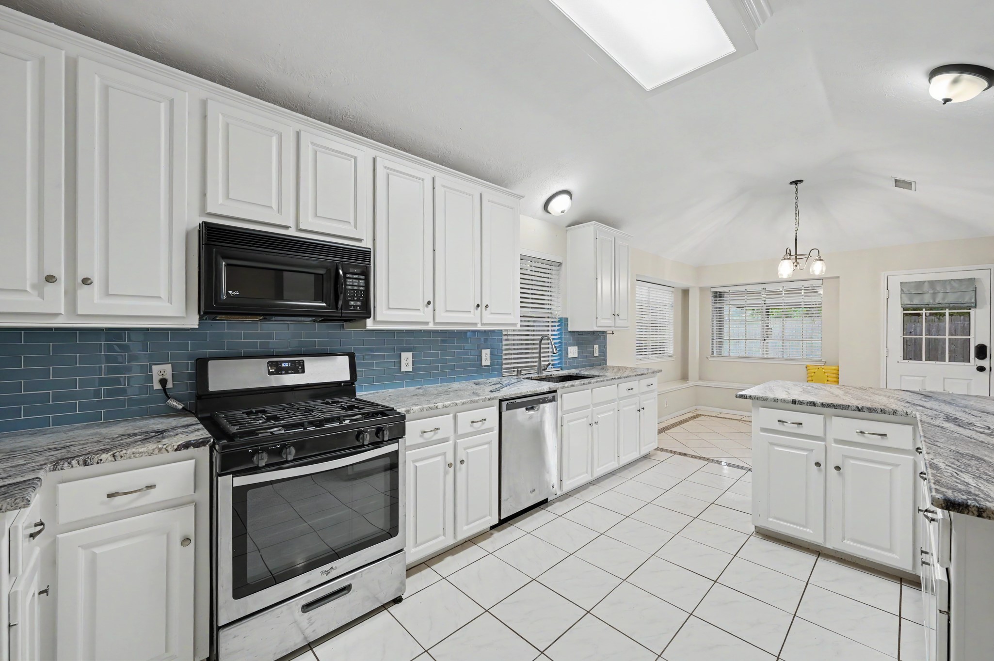 Large kitchen w/ upgraded granite counters, stainless appliances and plenty of storage