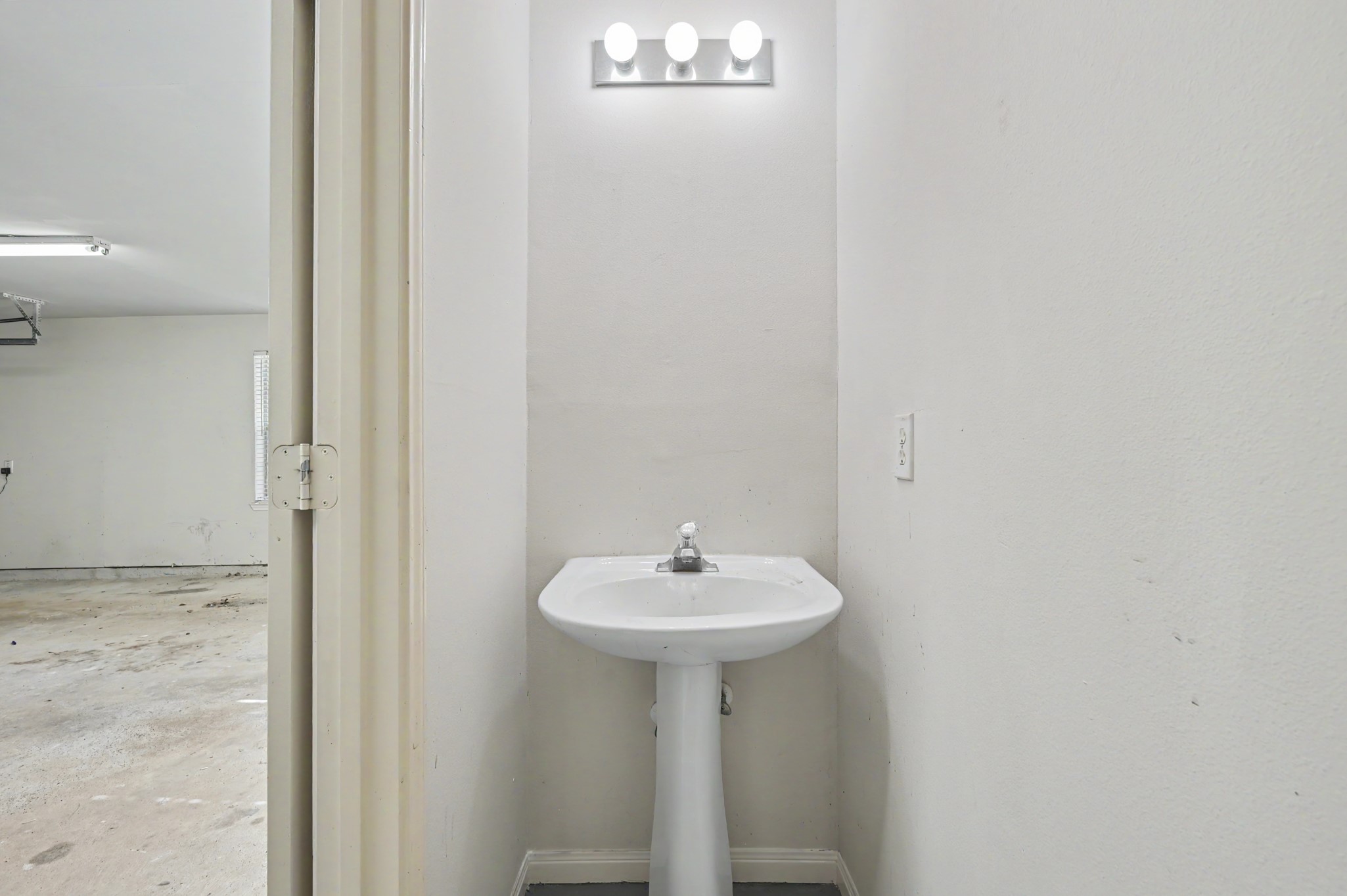 1/2 bath in garage is perfect for cleaning up after working outside