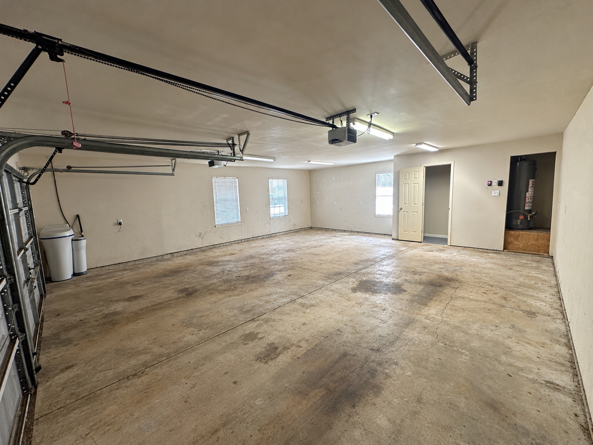 Oversized garage w/ added storage, 1/2 bathroom and Water softener.