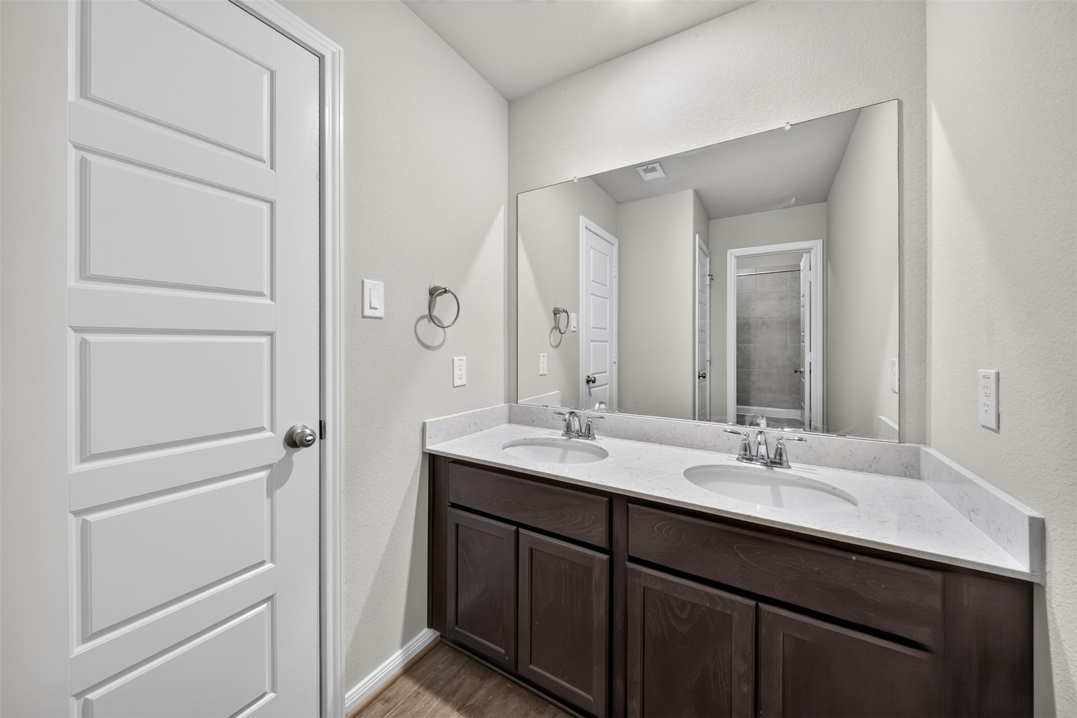 Bathroom 2 with double sinks and private bath area.