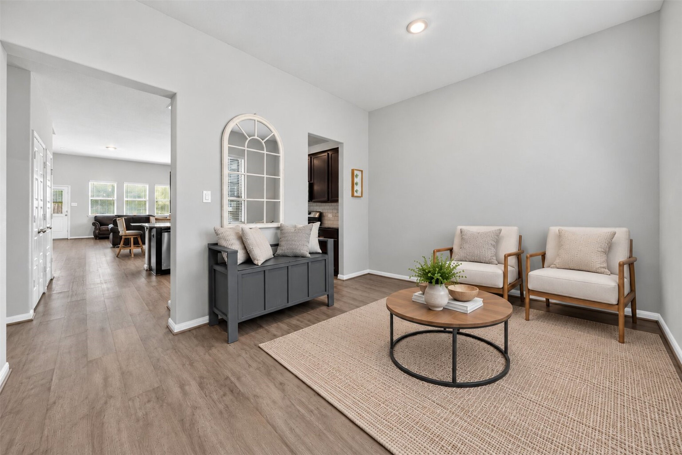 Entry welcomes you with an open concept flex space that can be utilized as a sitting room, office or play area for littles!
(virtually staged furniture).