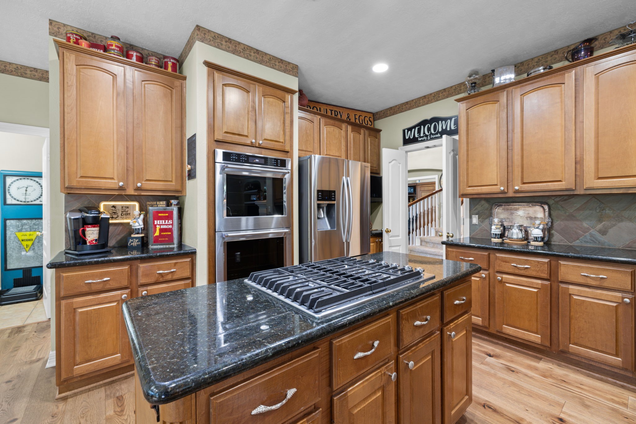 Kitchen features island, tons of cabinets and granite countertops