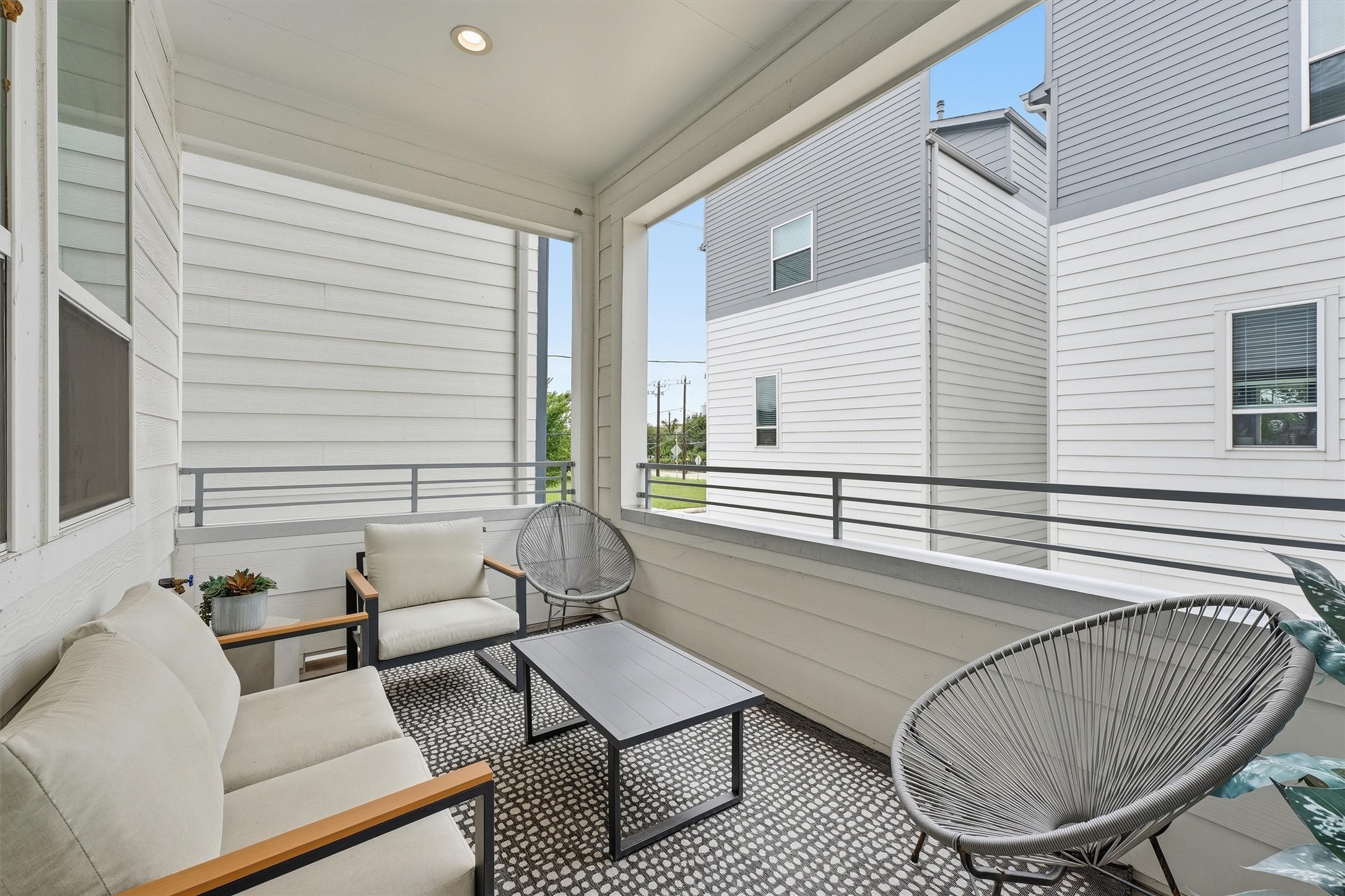 Experience serene outdoor living on this stylish balcony, ideal for relaxation and entertaining in a modern setting. Experience serene outdoor living on this stylish balcony, ideal for relaxation and entertaining in a modern setting.