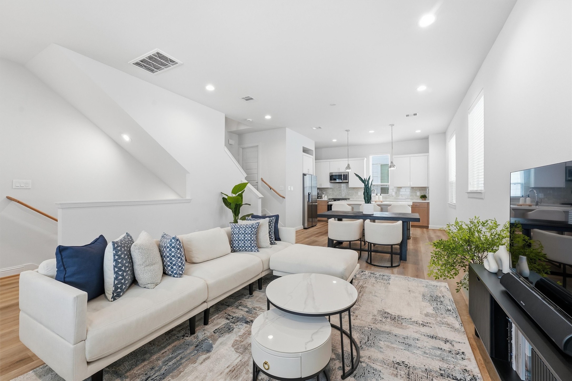 Discover seamless living in this bright, open-concept space where the living area flows into a stylish dining zone and sleek, modern kitchen. Discover seamless living in this bright, open-concept space where the living area flows into a stylish dining zone and sleek, modern kitchen.