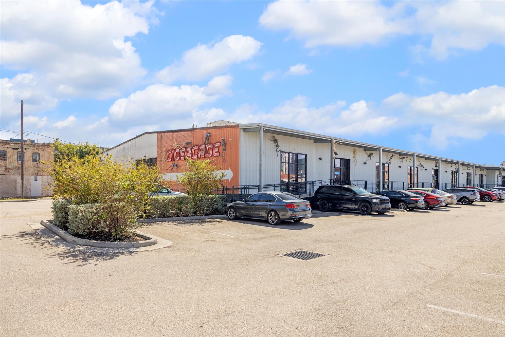 Modern arcade nearby with ample parking, featuring a distinctive facade and surrounded by well-maintained landscaping.