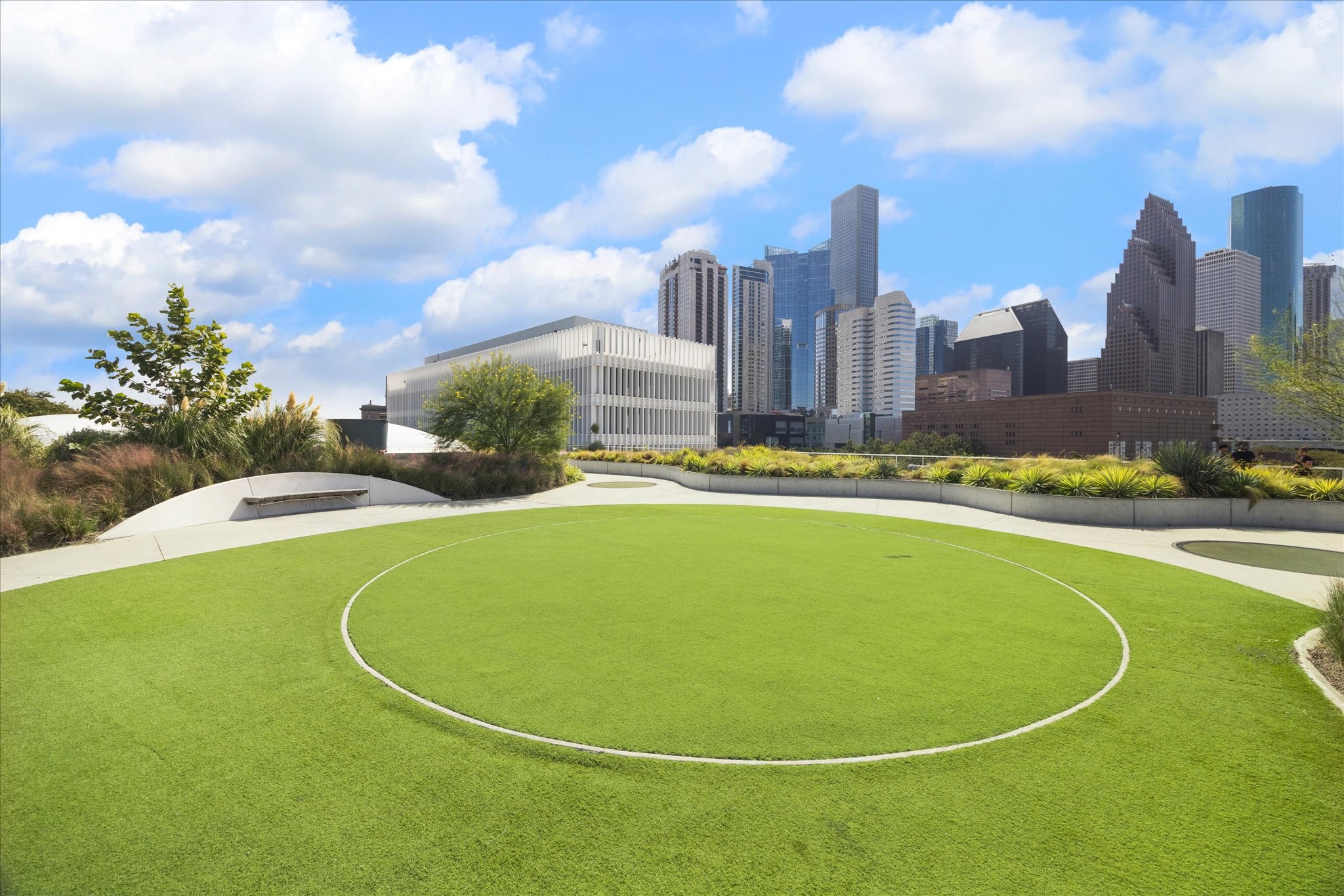 Enjoy an expansive rooftop green space nearby with breathtaking city skyline views, perfect for relaxation and gatherings.