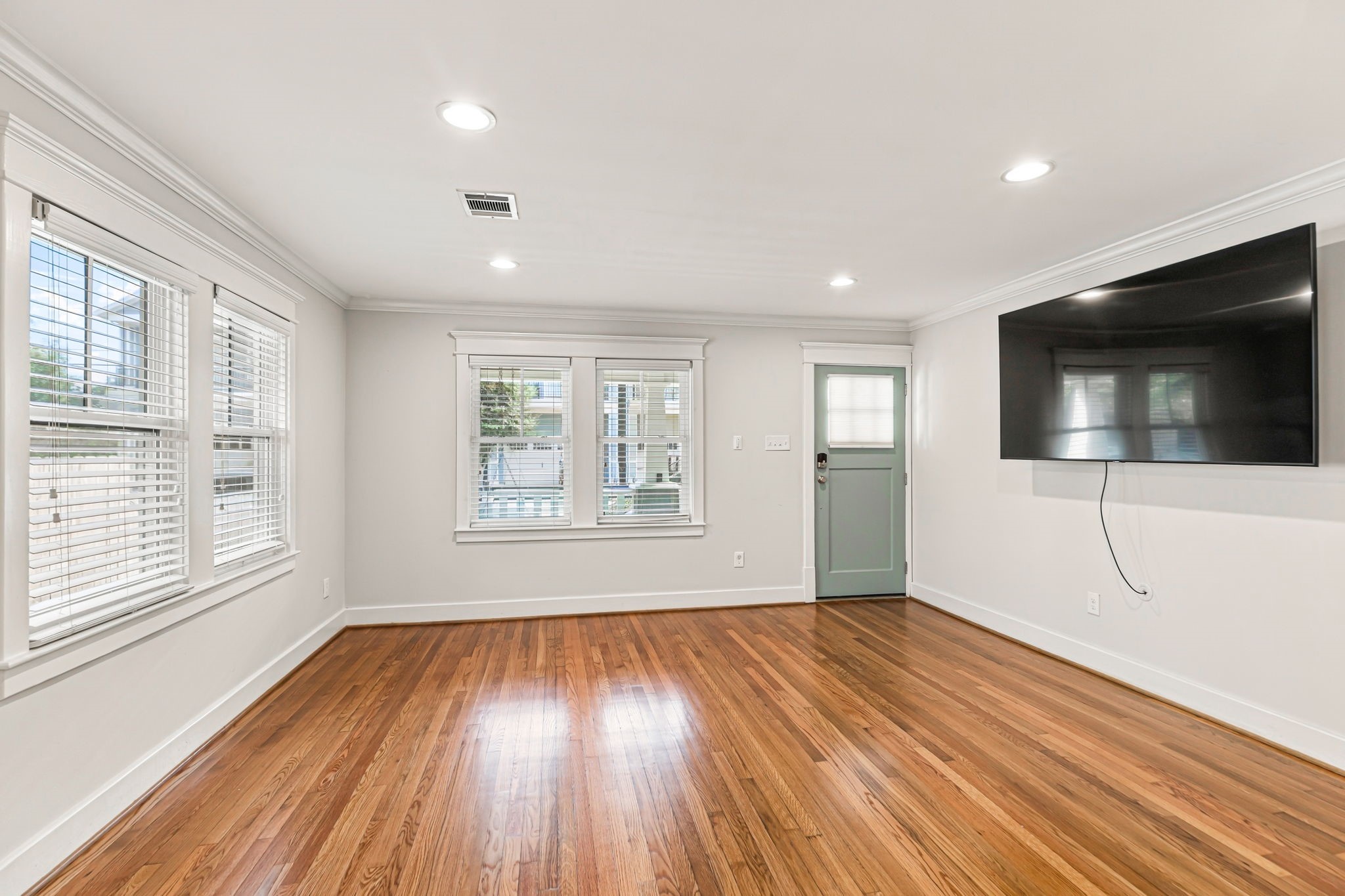 Huge living area fully open to the kitchen.  Home comes with a large mounted TV.