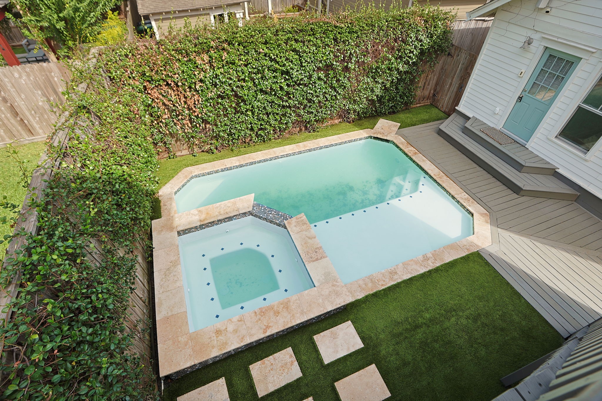 Low maintenance yard with artificial turf.