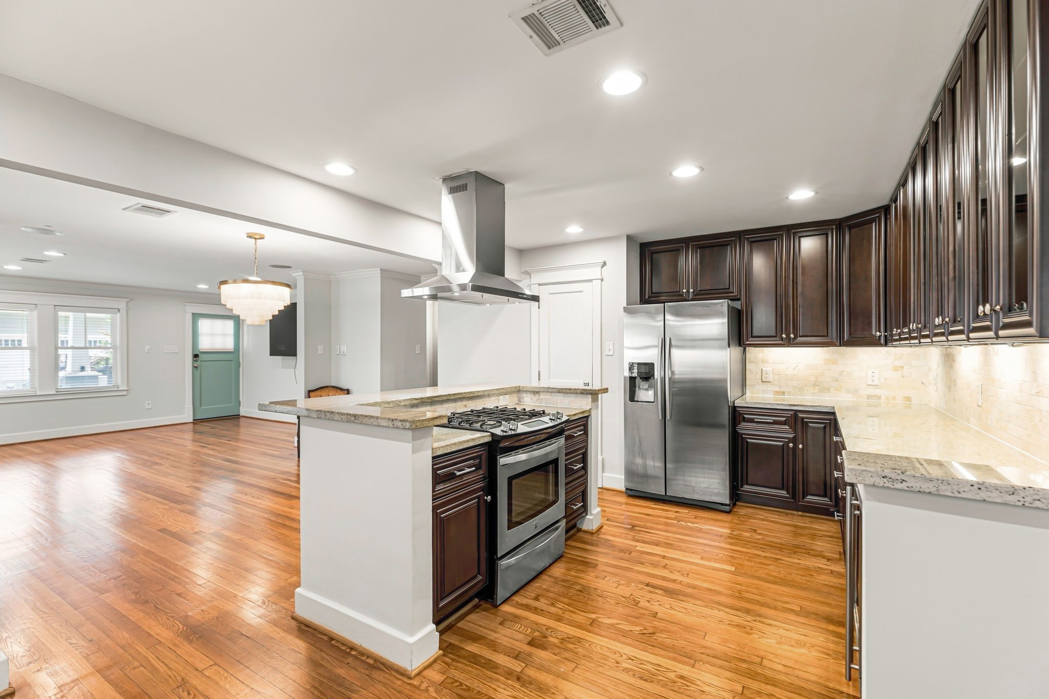Kitchen with gas cooking, new range hood, under cabinet lighting with plenty of storage.