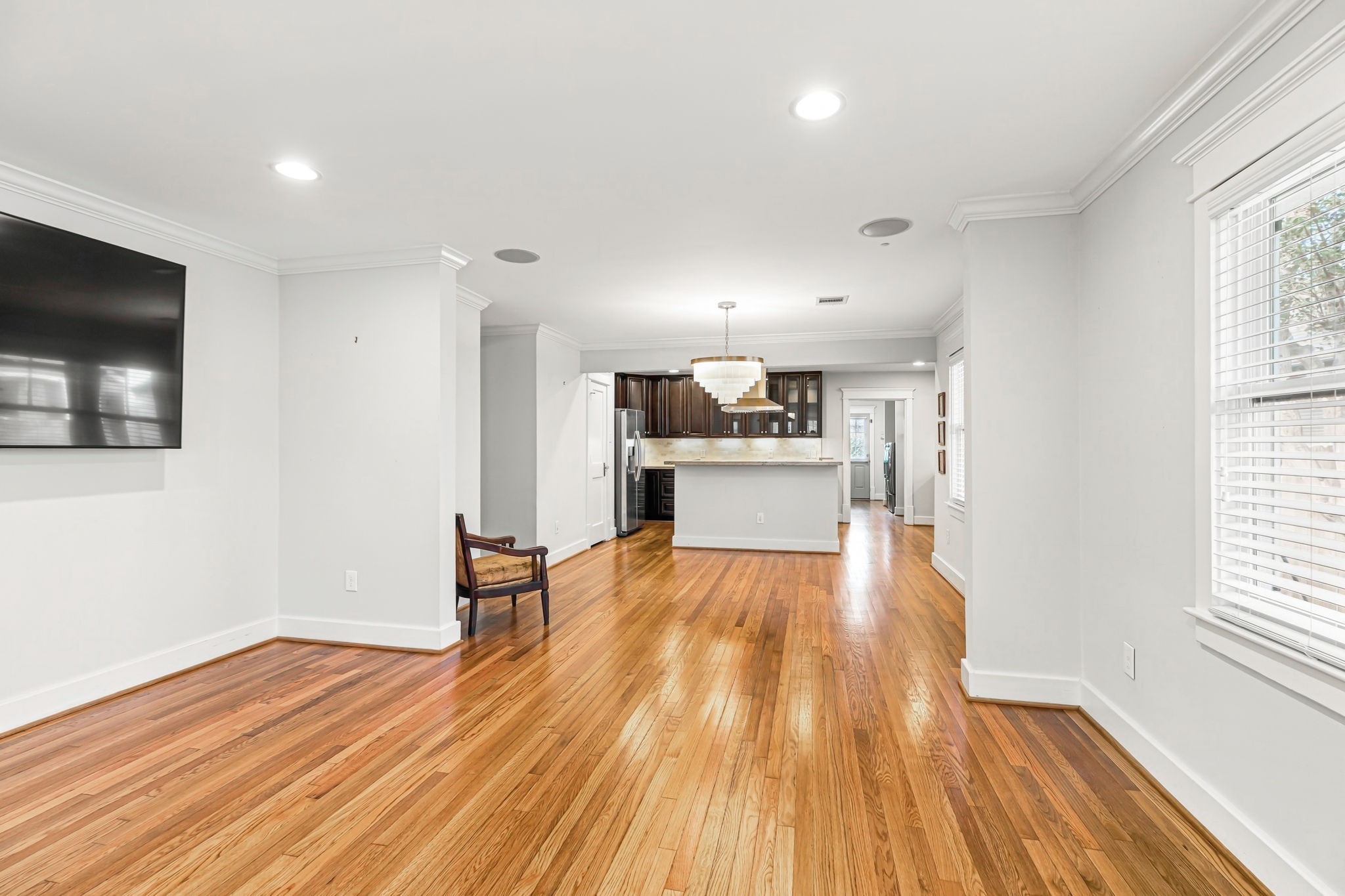 Living room with high ceilings fully open to the kitchen.