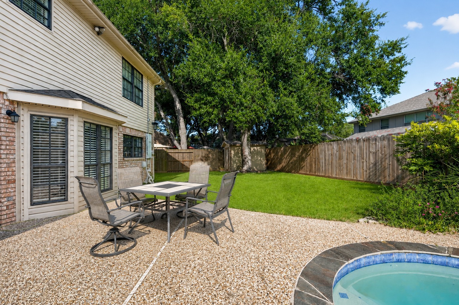 Virtually Cleaned: This spacious backyard offers the perfect combination of outdoor entertaining and green space.