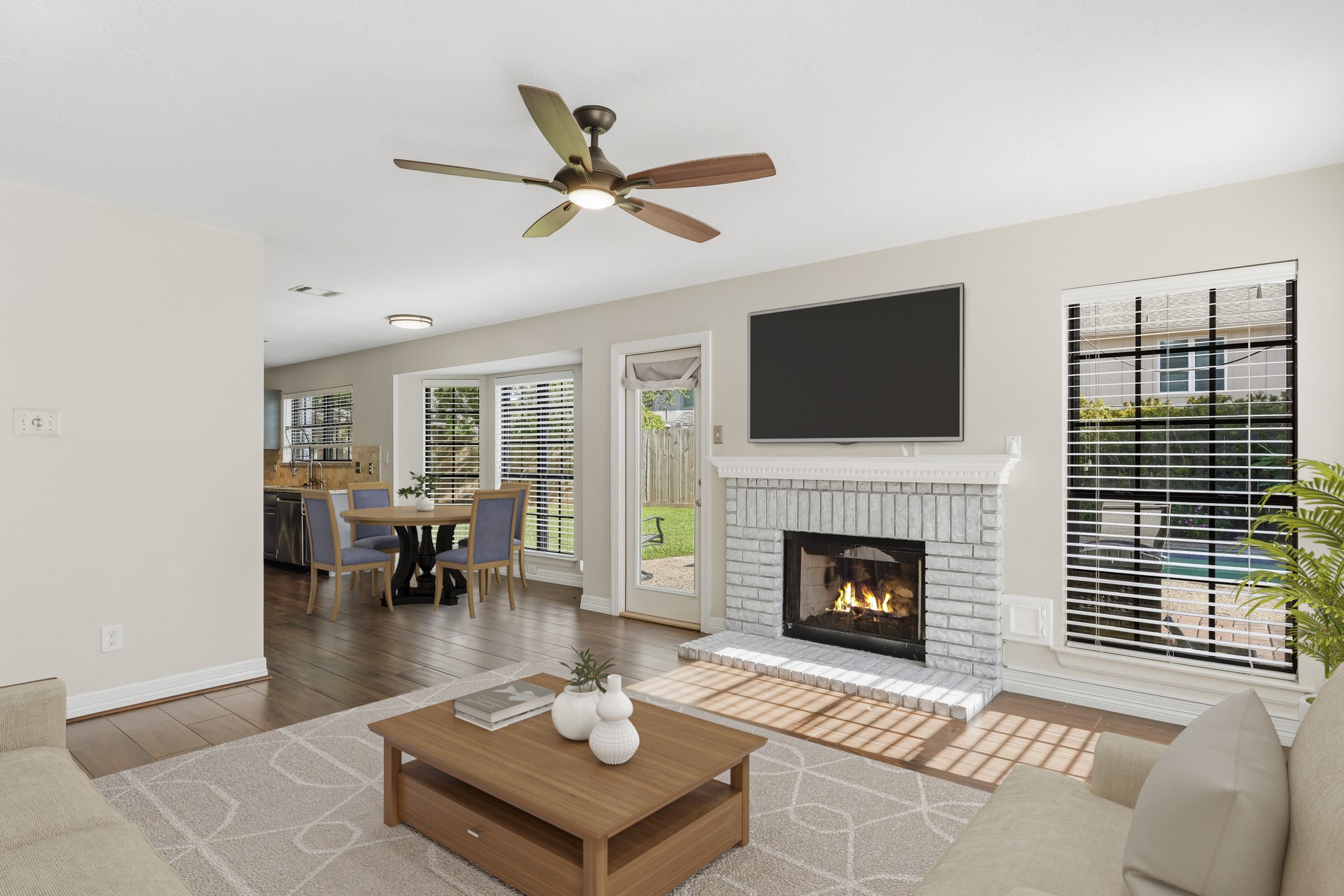 Virtually Staged: The open layout flows seamlessly toward the adjoining kitchen and breakfast area, while a glass-paneled door provides convenient backyard access.
