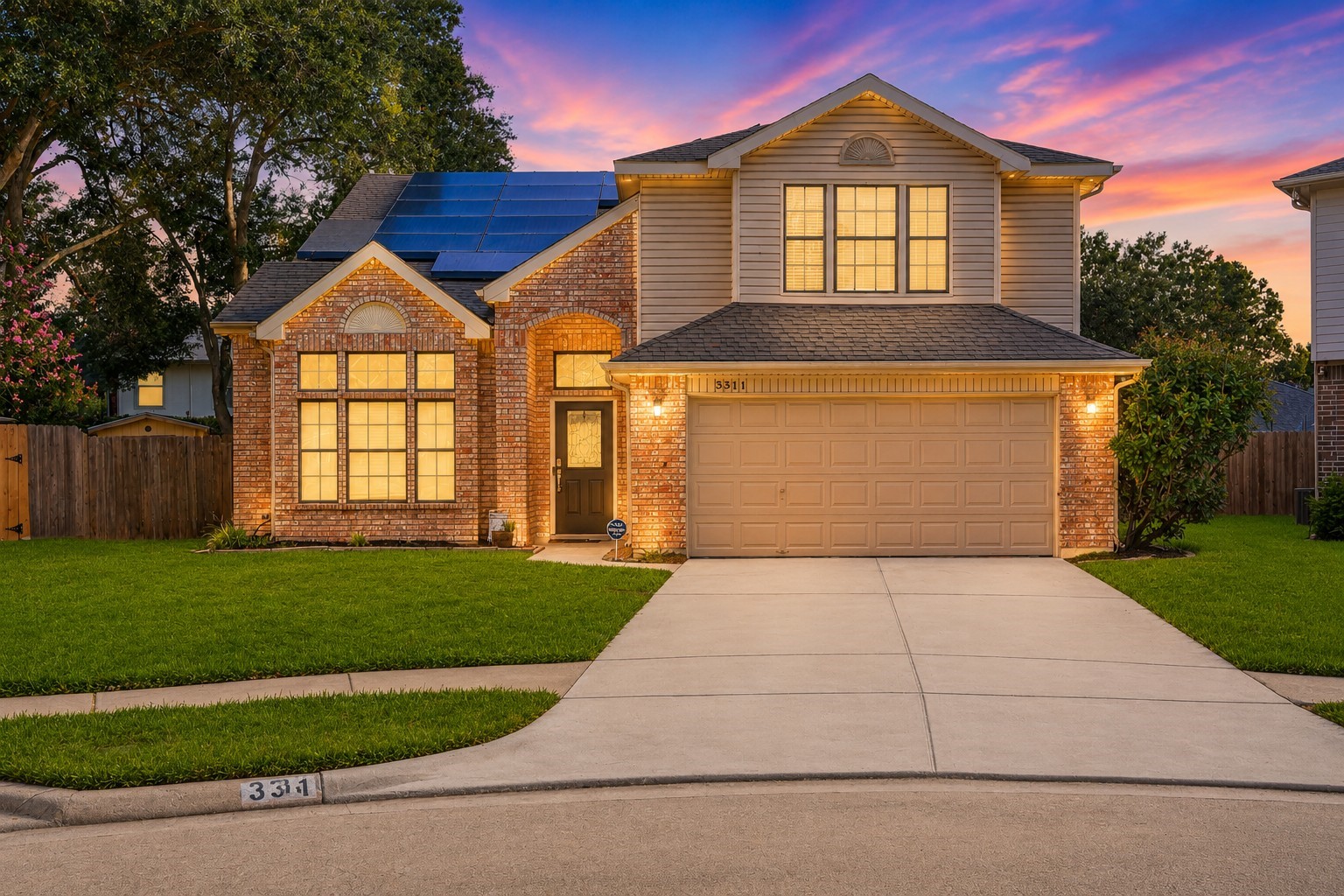 This inviting two-story home features classic brick and siding exterior, a spacious two-car garage, and a well-maintained front lawn. Large windows add character and natural light, while the covered entry creates a welcoming first impression.