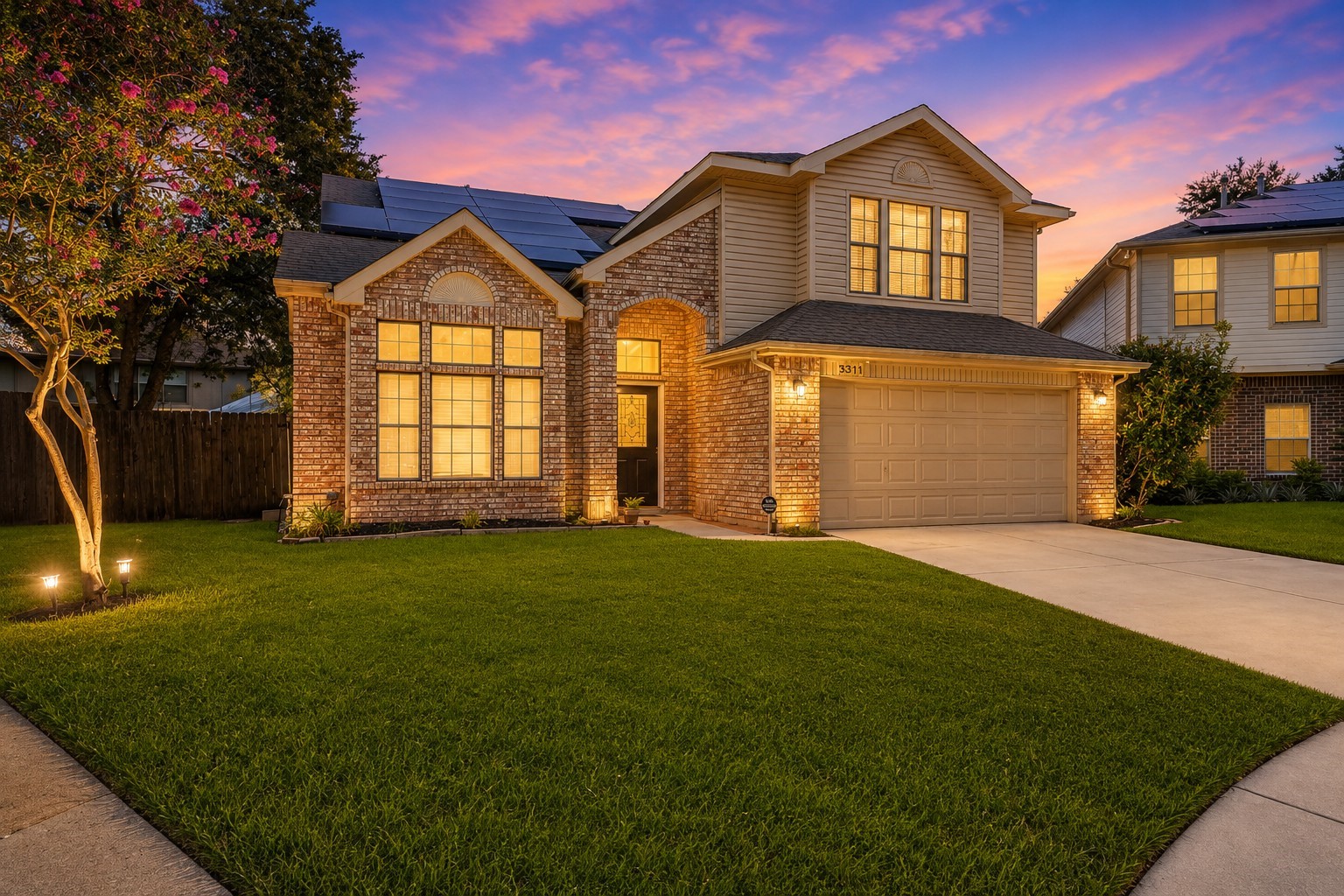 Solar panels provide an additional energy-efficient feature, completing the homes attractive and functional exterior.