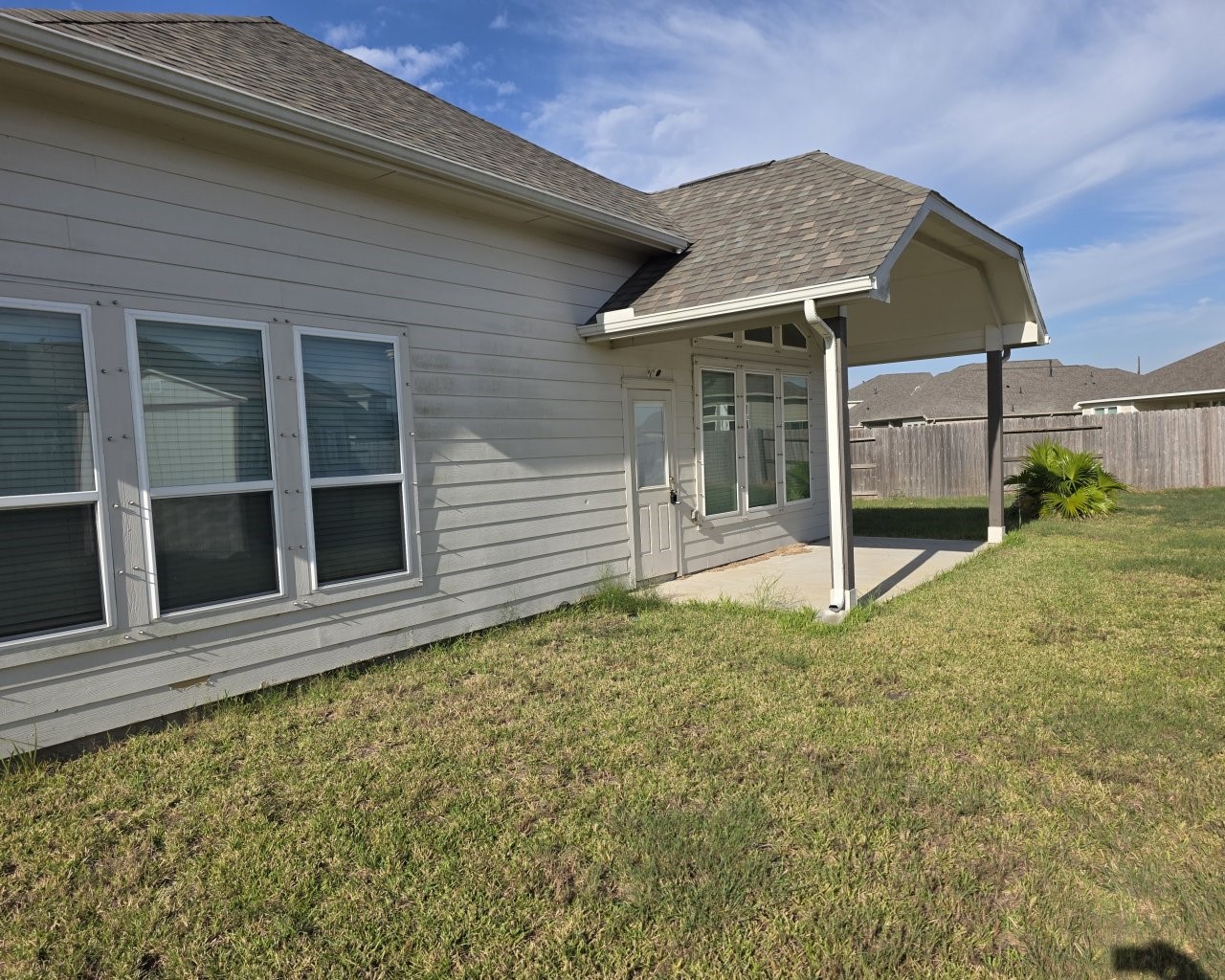 View of the back with a covered patio