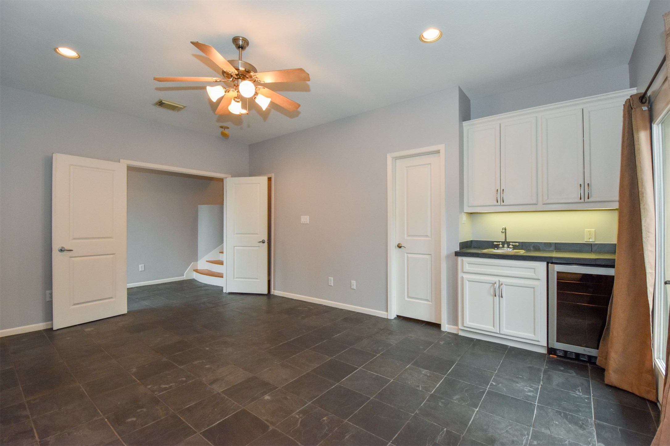 Downstairs flex room with beverage refrigerator & sink... just off the front entry Downstairs flex room with beverage refrigerator & sink... just off the front entry