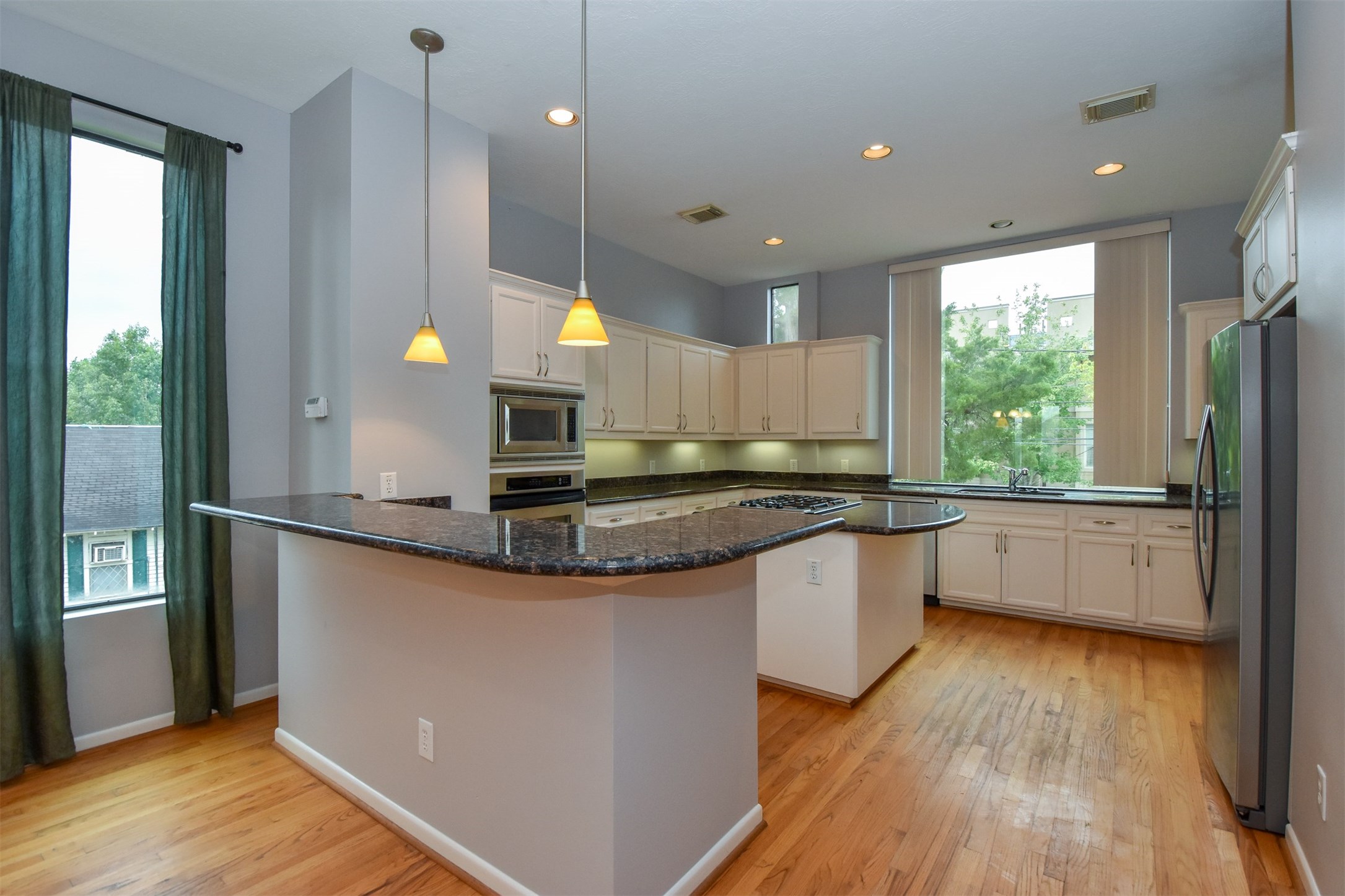 Open kitchen with room for bar stools on granite countertops