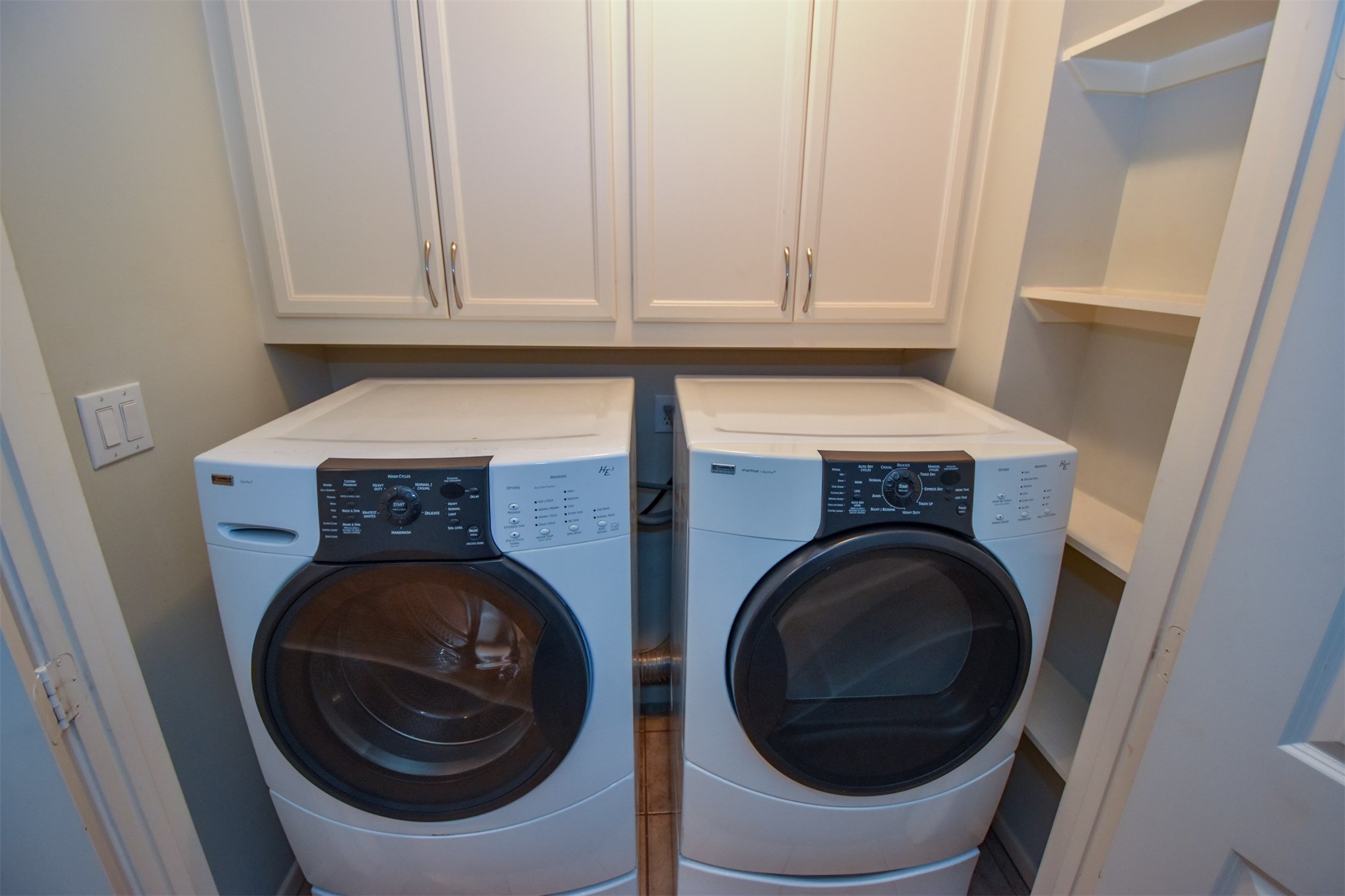 Washer & dryer in hallway on third floor, between primary and secondary bedrooms