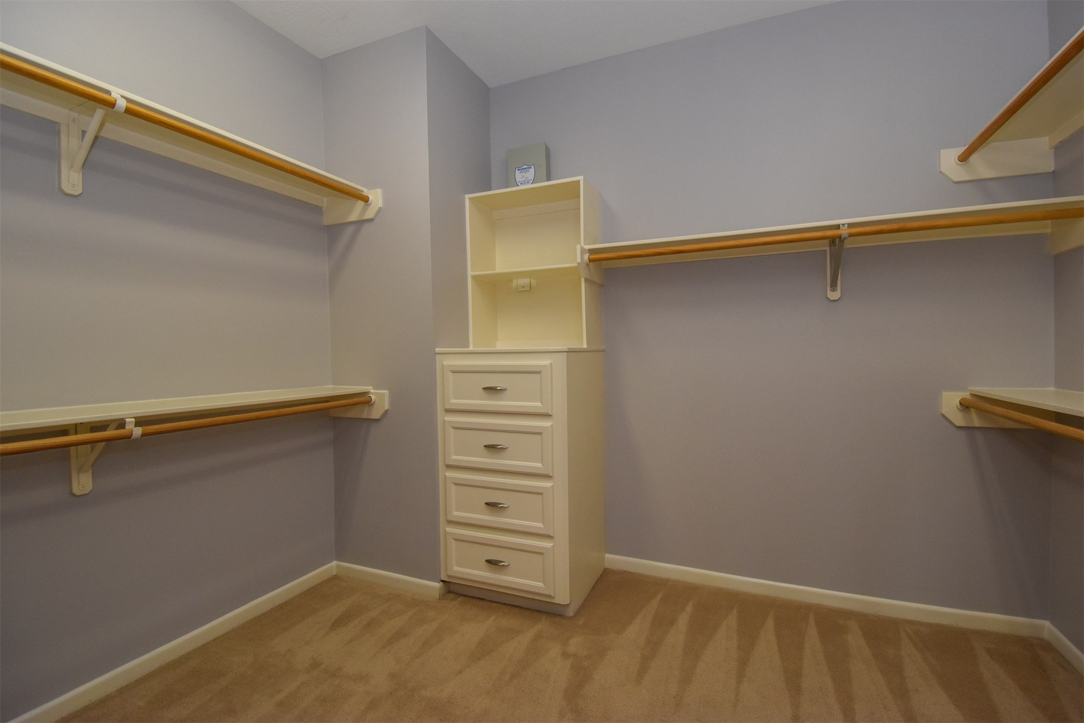 Nice spacious master closet with built-in cabinets and shelves