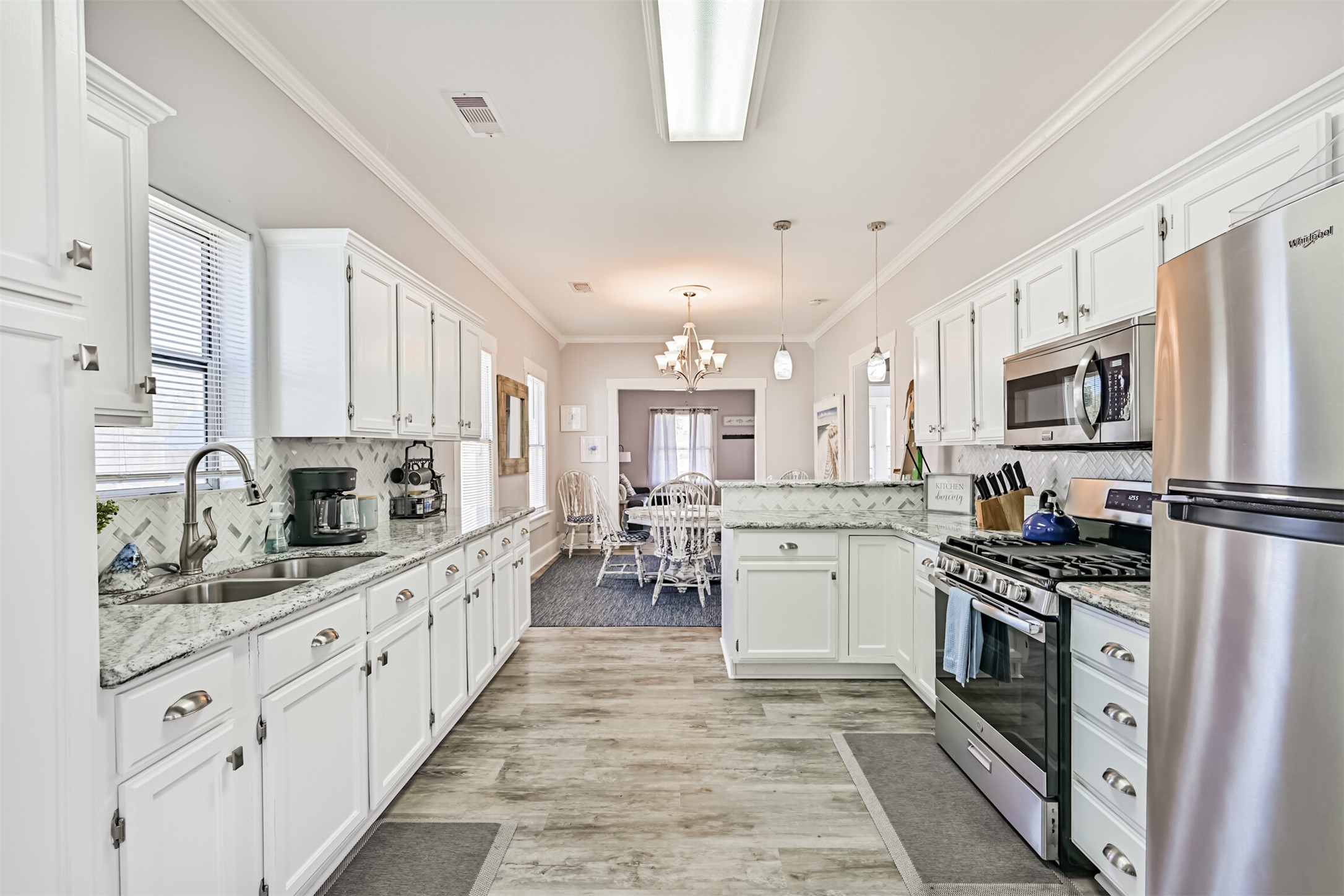 An Additional Shot for Layout Perspective Between the Kitchen, Dining and Living Rooms! Nice Flooring was Recently Installed as Well!
