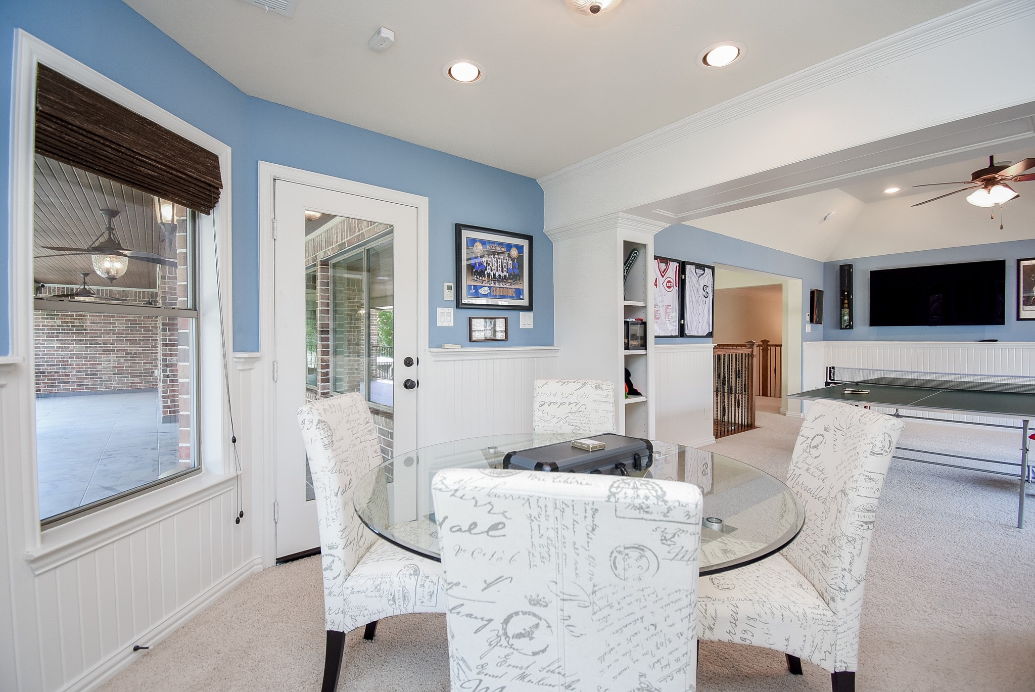 The card room off the main part of the gameroom has built in shelves and access to the large balcony.