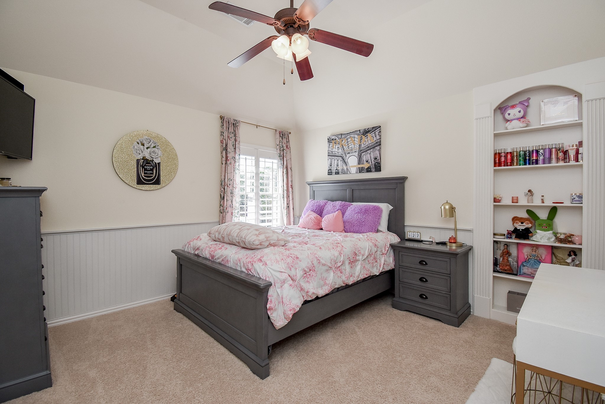 Bedroom one upstairs has wainscotting, plantation shutters, book case and a gambrel ceiling.