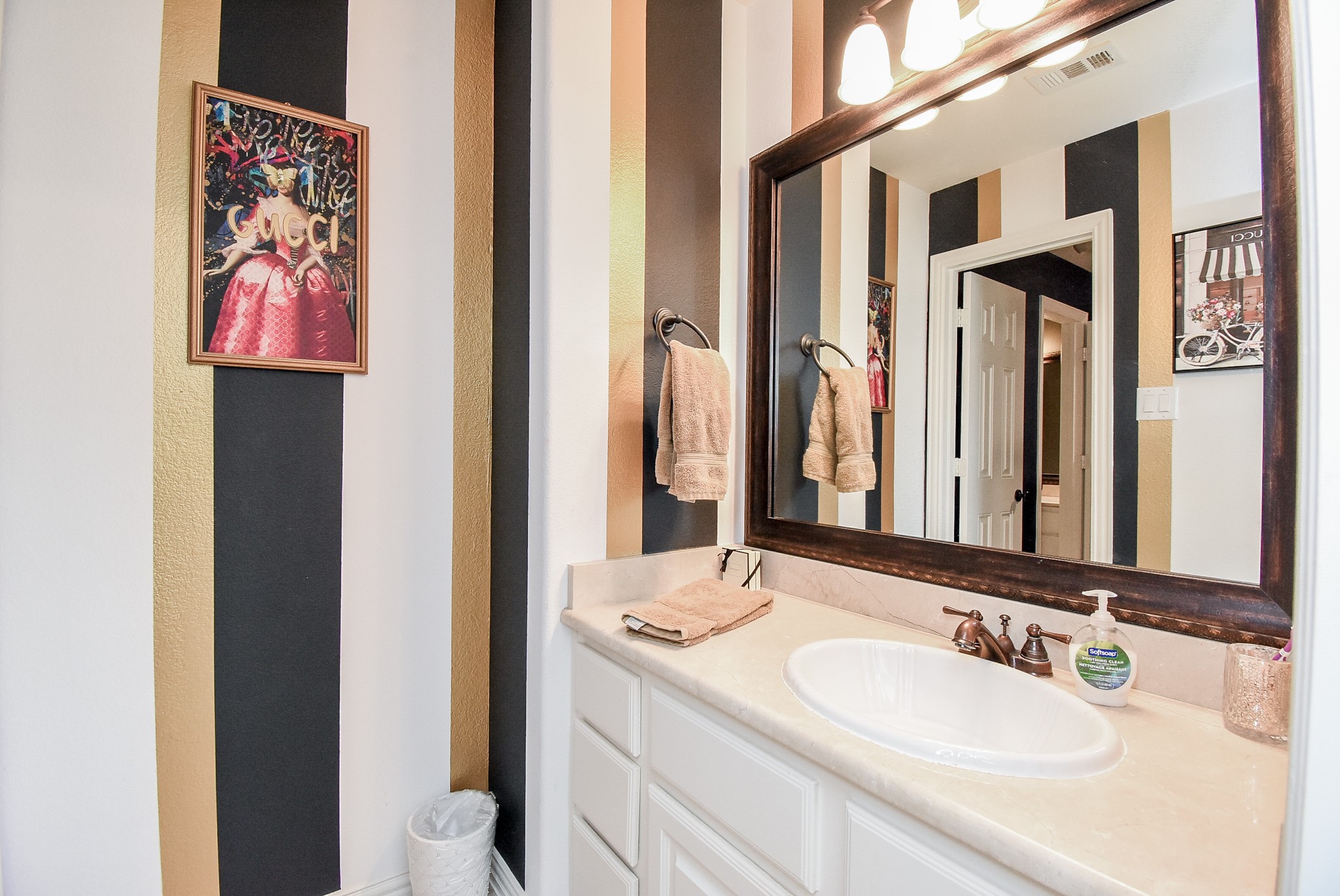 Vanity for bedroom two is part of a hollywood bath. Good counter space, framed mirror and storage.