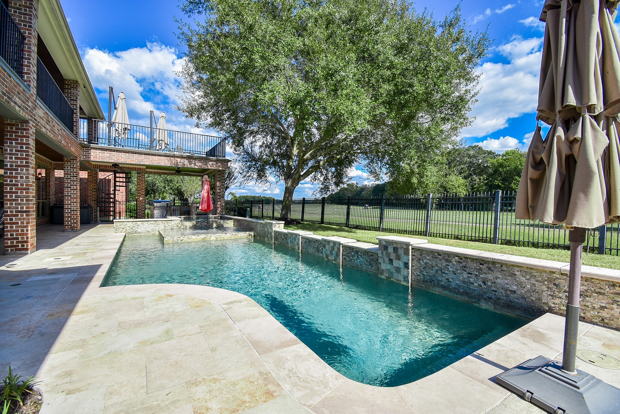 Viewof the beautiful pool area. Travertine tile and pretty accent tiles tie into the natural look of the enviornment. Viewof the beautiful pool area. Travertine tile and pretty accent tiles tie into the natural look of the enviornment.