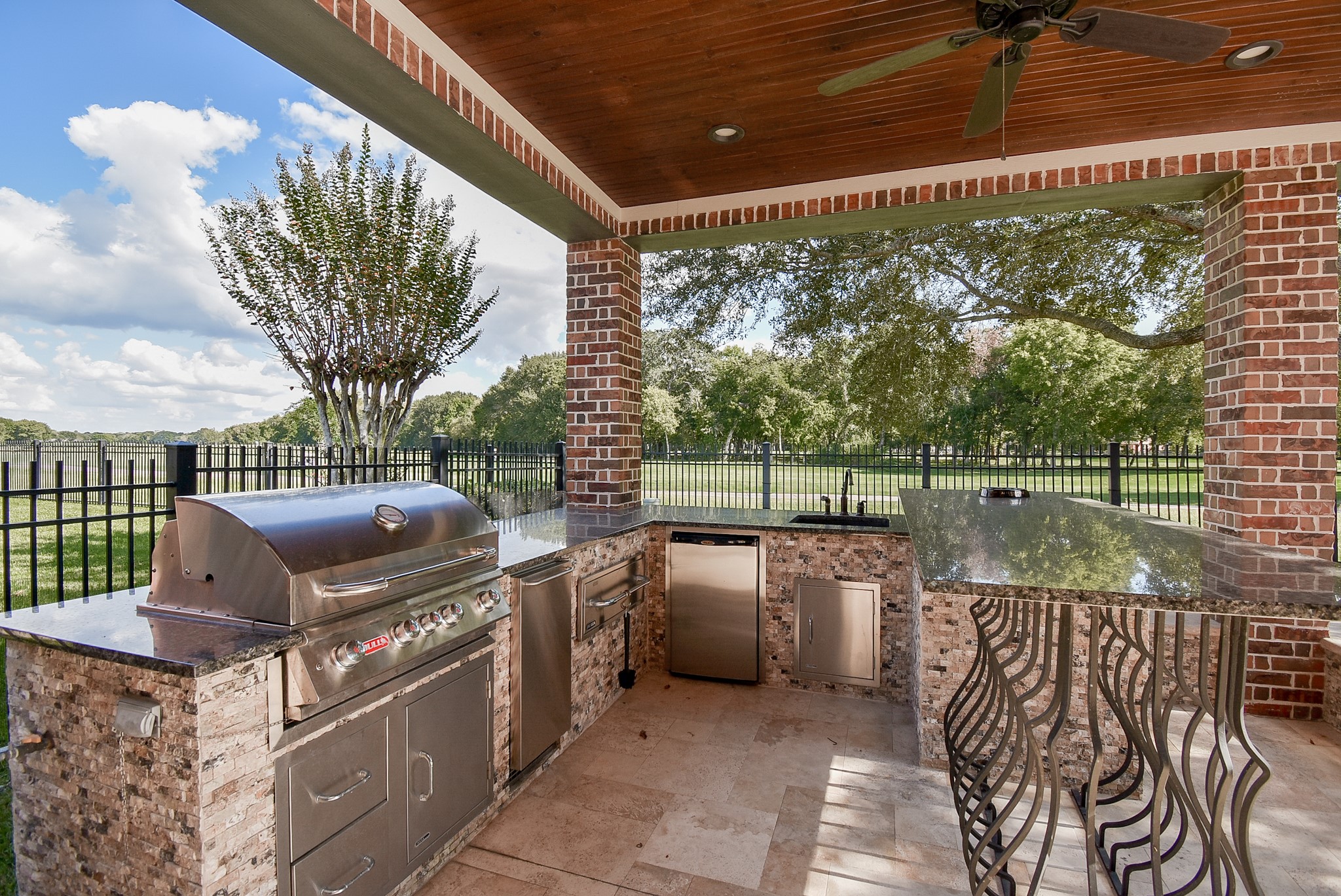 Outdoor entertaining is such a plus. Enjoy the views while grilling your favorite meal. High top granite bar area is perfect for bar stools . Plenty of prep space. Bead board ceiling.