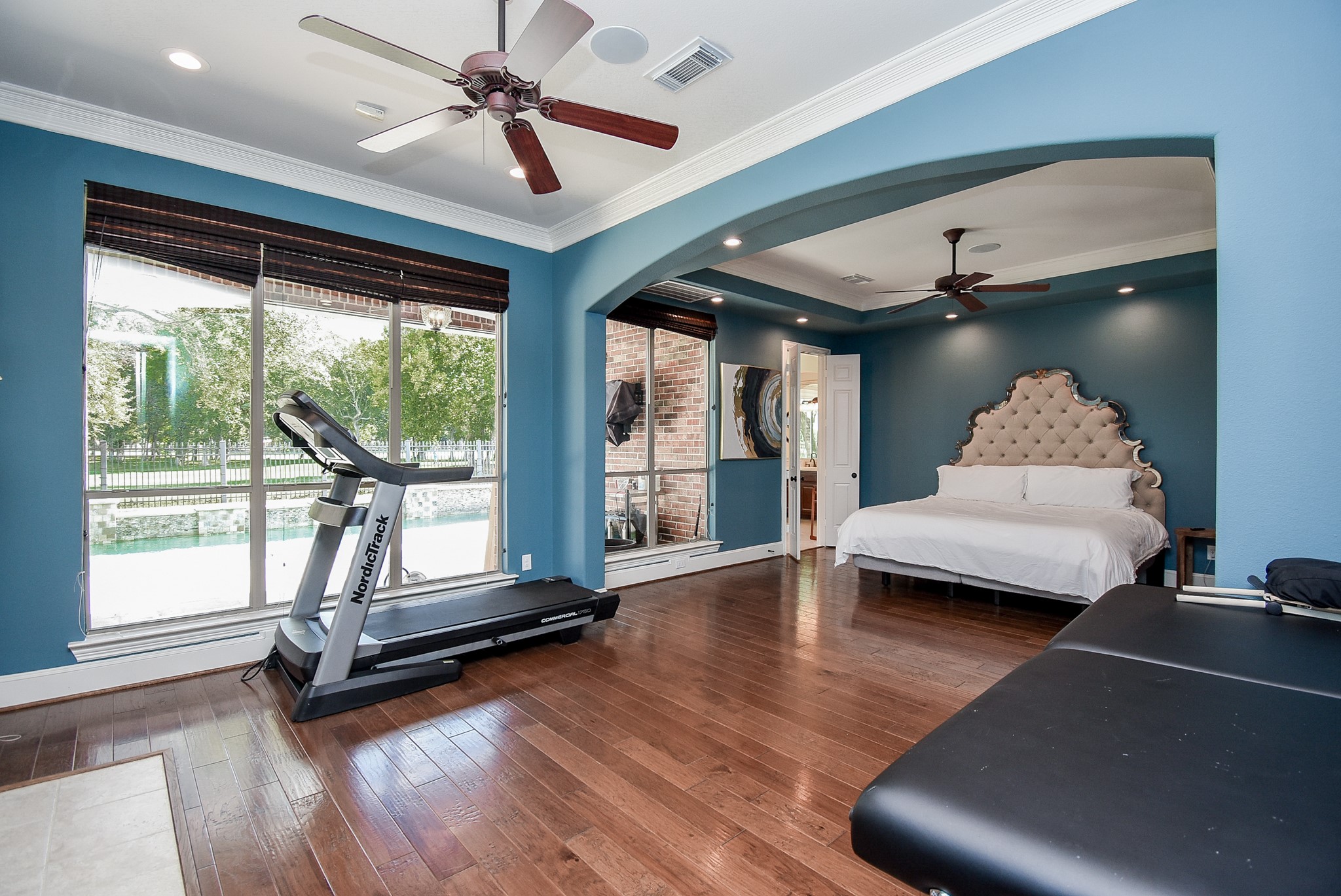Primary suite down has a separate sitting area Pretty crown molding and accent lights. Hardwood flooring and windows with a view.