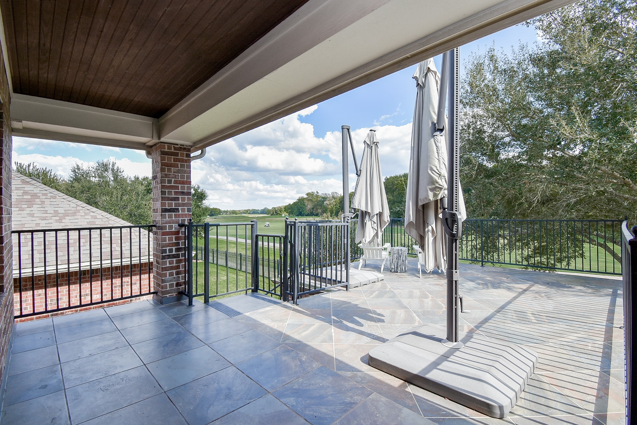 An extension of this balcony is uncovered to catch some rays. Staircase leading to the lower level. Great view of the long fairway.