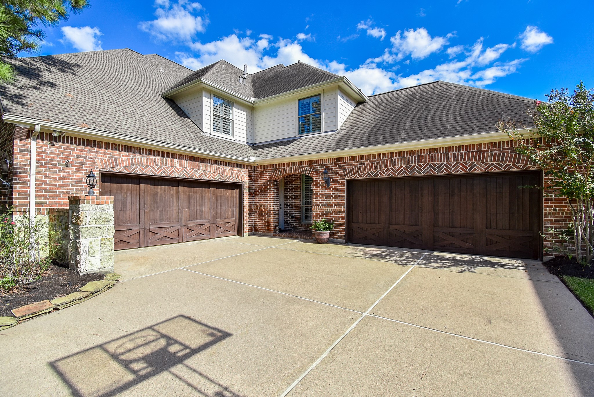 Fantastic four car garage with Covered porch allowing access to the interior of the home as well as one of the two car garages.