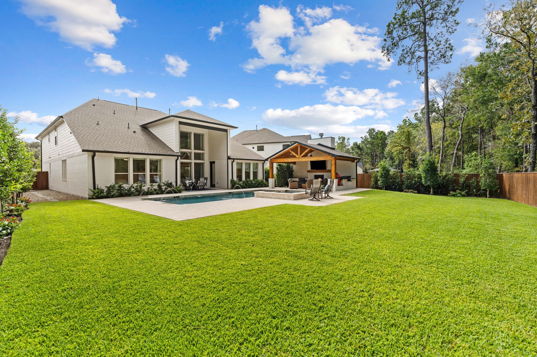 Backyard oasis featuring a vaulted cabana w/fireplace & outdoor kitchen, sparkling heated pool with tanning ledge, raised spa, elegant water features, and expansive travertine decking. Surrounded by lush landscaping and a wooded greenbelt, and hardscape side yards for low maintenance--this unusually large backyard offers exceptional privacy and a true resort-style experience! Backyard oasis featuring a vaulted cabana w/fireplace & outdoor kitchen, sparkling heated pool with tanning ledge, raised spa, elegant water features, and expansive travertine decking. Surrounded by lush landscaping and a wooded greenbelt, and hardscape side yards for low maintenance--this unusually large backyard offers exceptional privacy and a true resort-style experience!