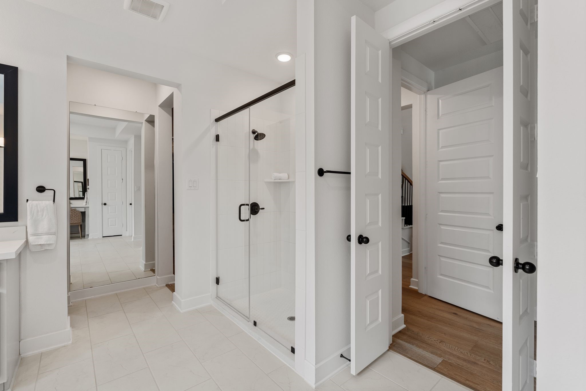 Primary retreat also offers his-and-hers closets w/direct laundry room access