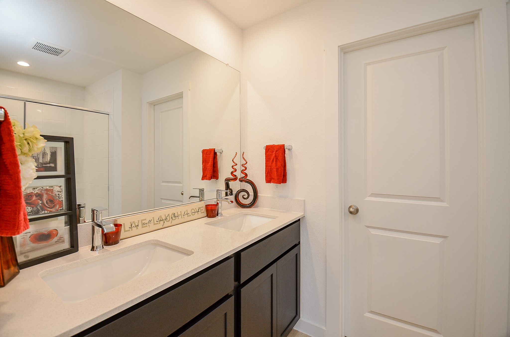 Modern bathroom featuring a sleek double vanity with a large mirror.