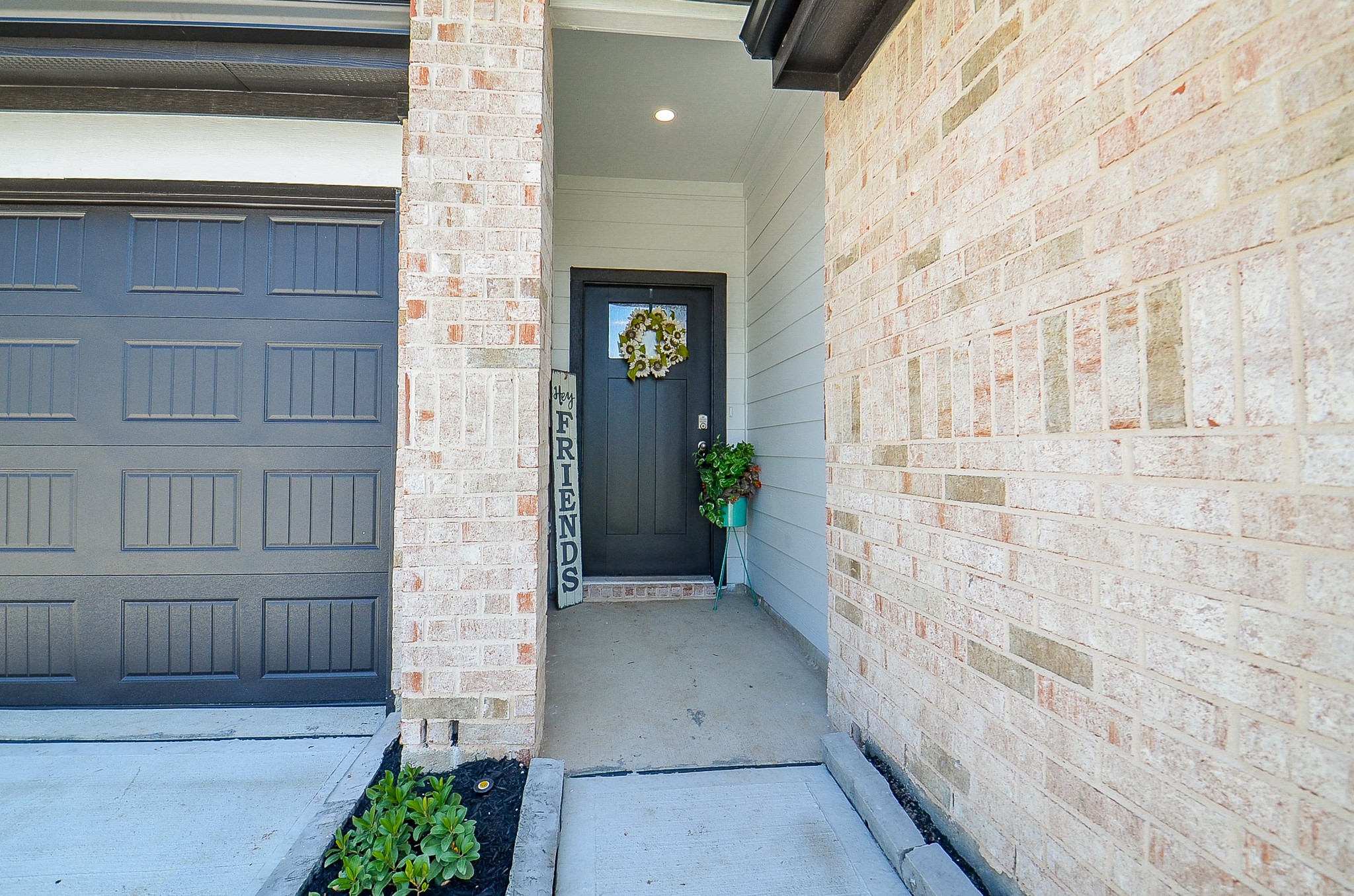 Charming entryway with a welcoming front door set against a backdrop of elegant brickwork.