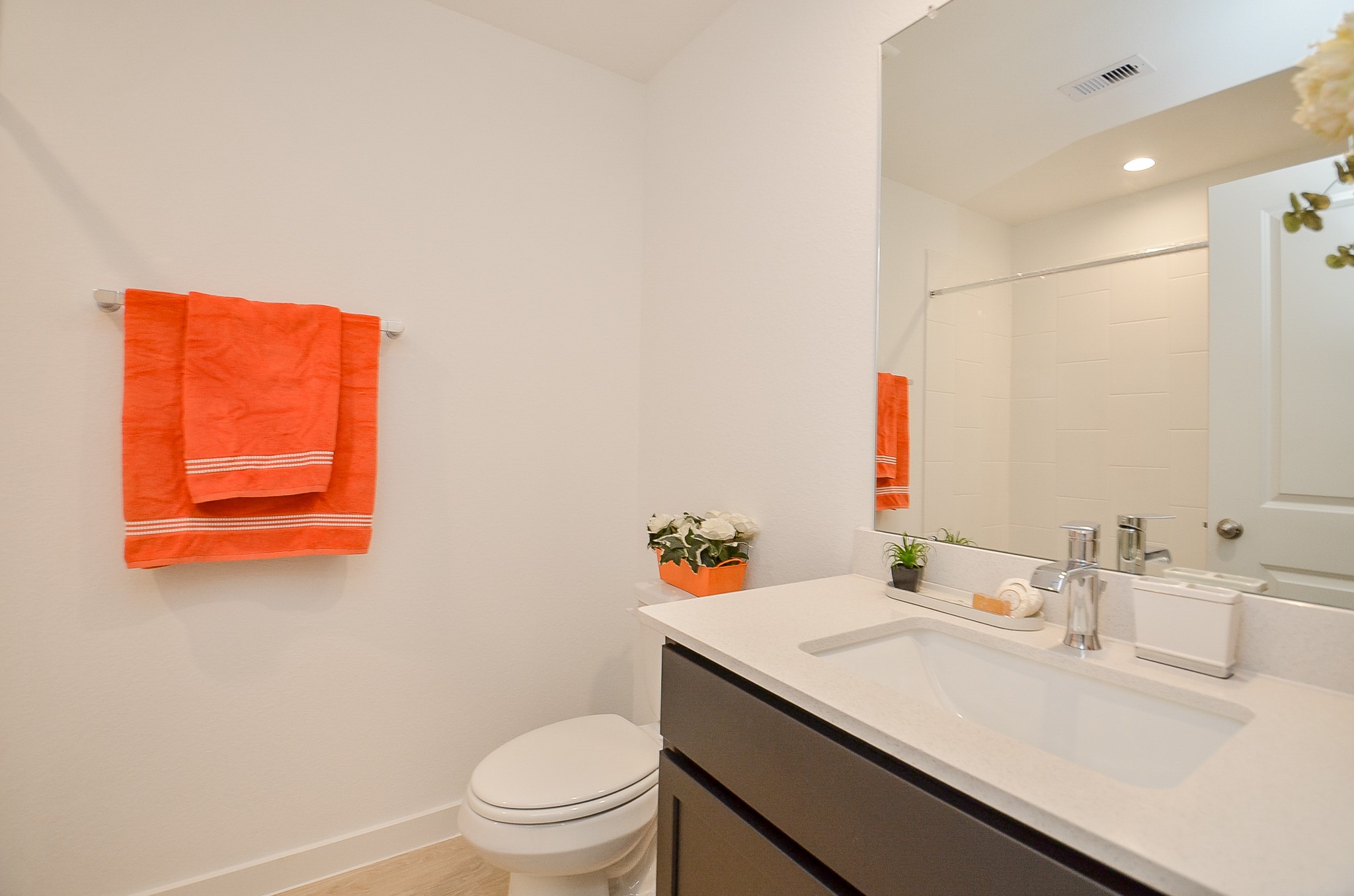 Bright and inviting bathroom featuring a sleek vanity, modern fixtures and a fresh color palette.