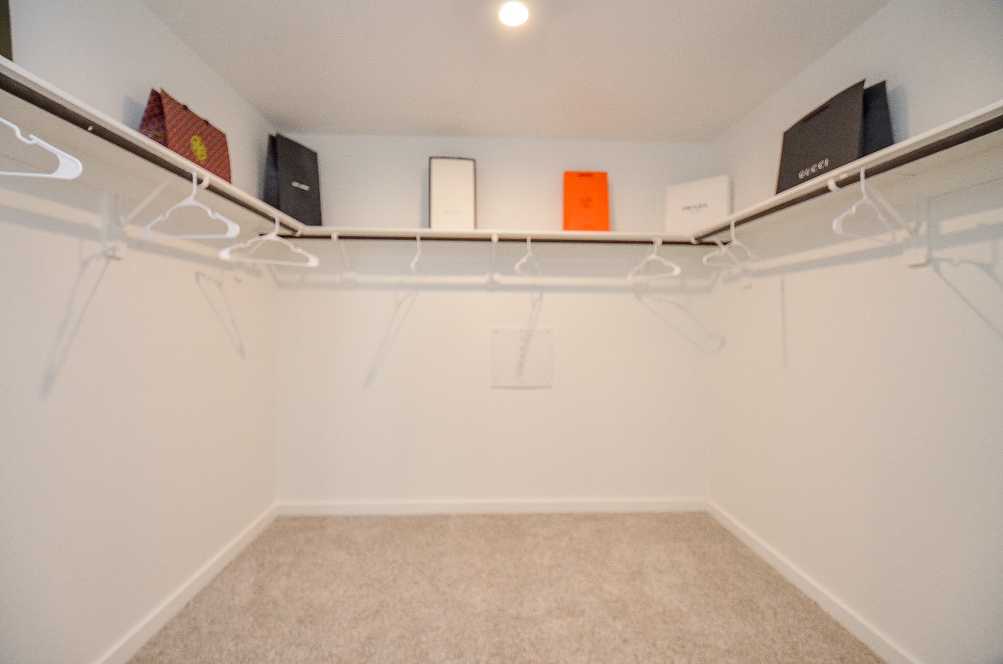 Spacious walk-in closet with ample shelving and hanging space, perfect for organizing your wardrobe.