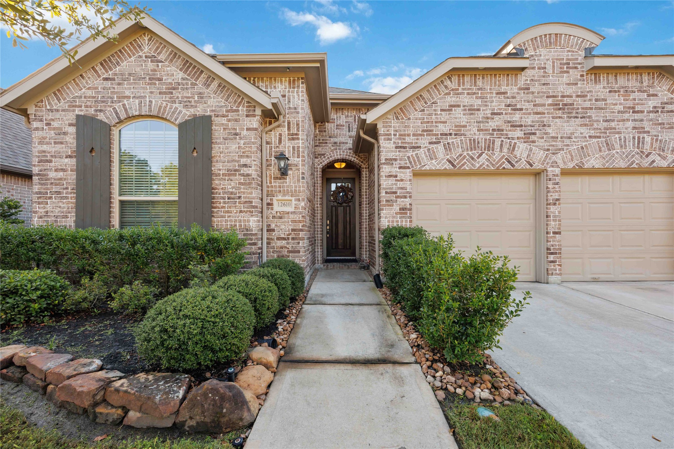 This beautiful home features a charming brick exterior with arched windows and a welcoming pathway leading to the front door. Well-maintained landscaping enhances its curb appeal, and the two-car garage offers ample parking space. This beautiful home features a charming brick exterior with arched windows and a welcoming pathway leading to the front door. Well-maintained landscaping enhances its curb appeal, and the two-car garage offers ample parking space.