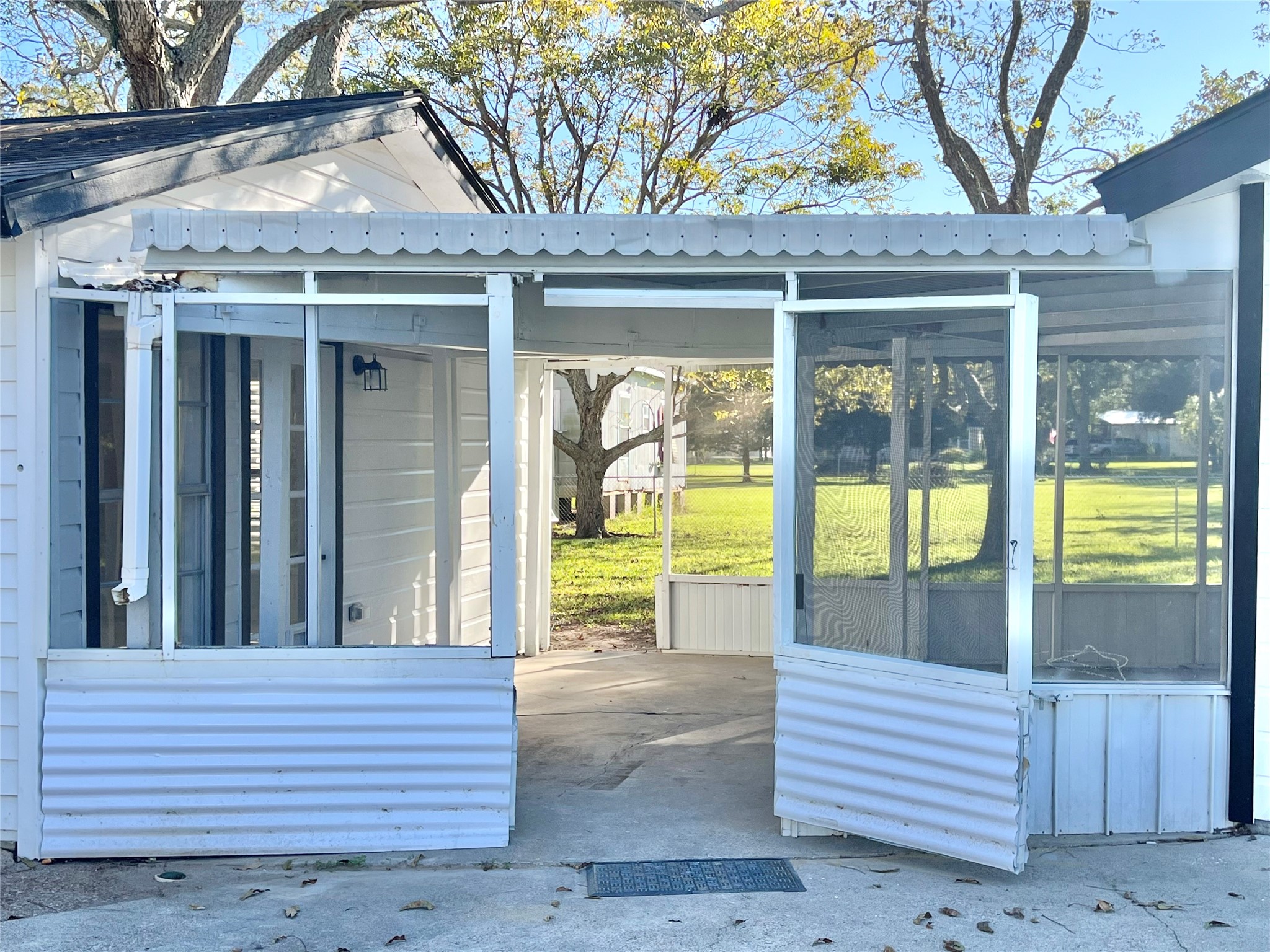 Coming out of the screened in back patio and going towards the He/She Shed or Home Office and also can cross over to the Kwanza Hut workshop or garage as well!