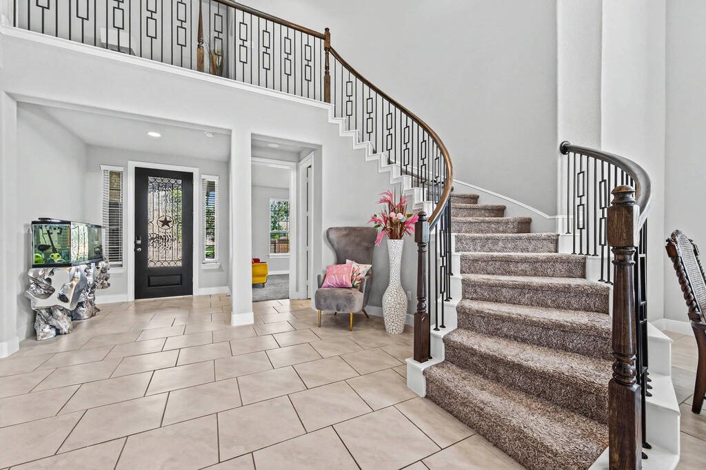 Grand entrance with spiral staircase and sky high ceiling!